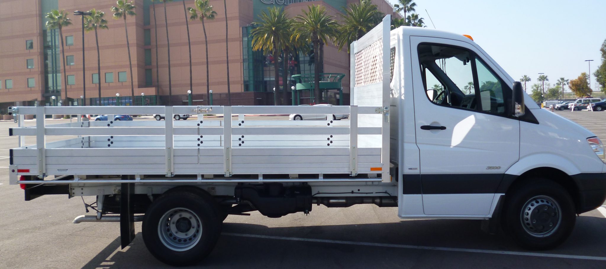 2015 Mercedes-Benz Sprinter 3500 DRW with a 7' X 12' AlumBody aluminum flat bed with 22" fold down gates and dock bumper