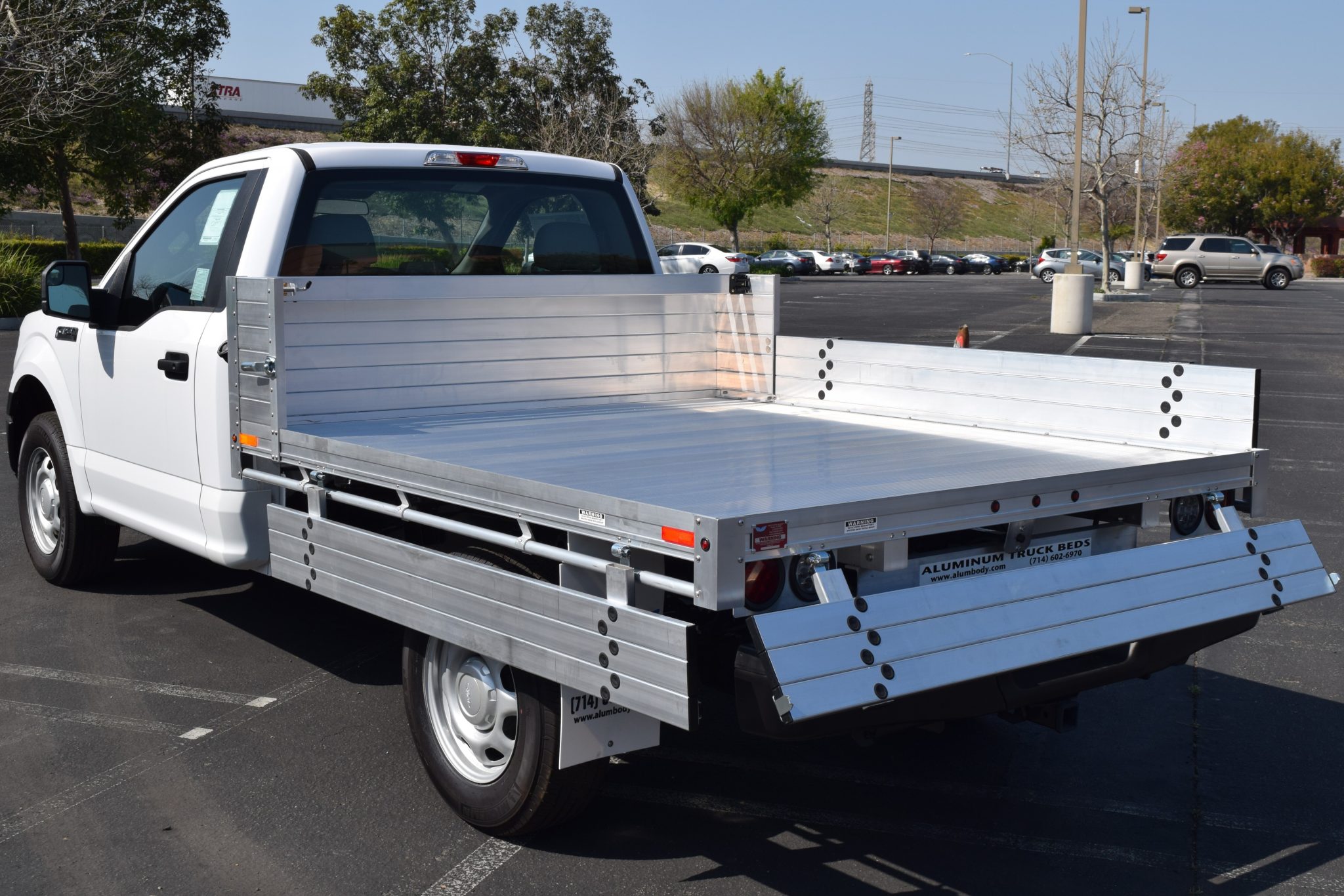 2019 Ford F150 with an 81" × 8' AlumBody aluminum pool truck bed with 9" solid fold-down gates using stainless steel hardware and the factory bumper, gates down