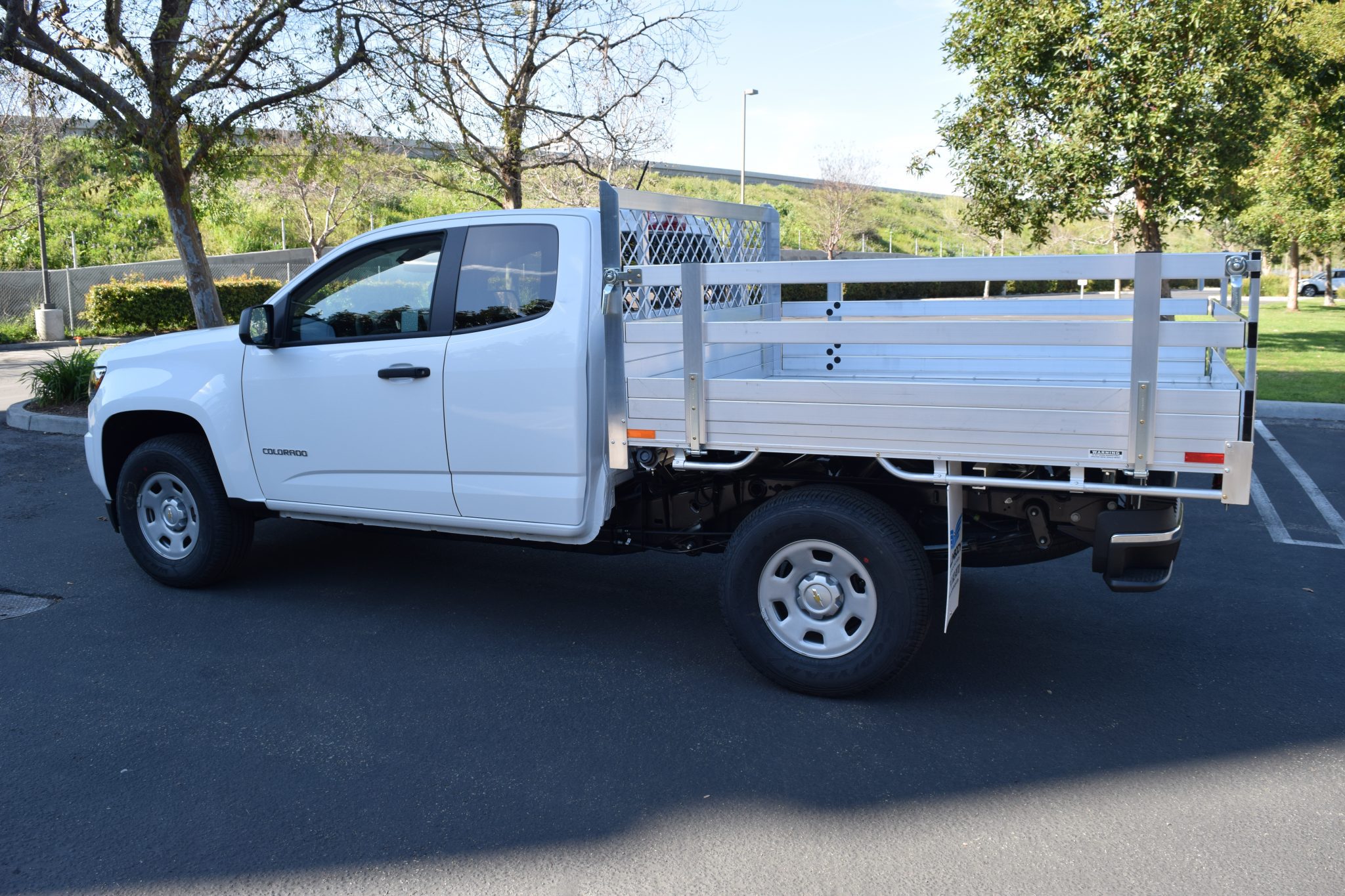 2017 Chevy Colorado with a 6' X 66" AlumBody aluminum flat bed with 22" fold down gates using the factory bumper