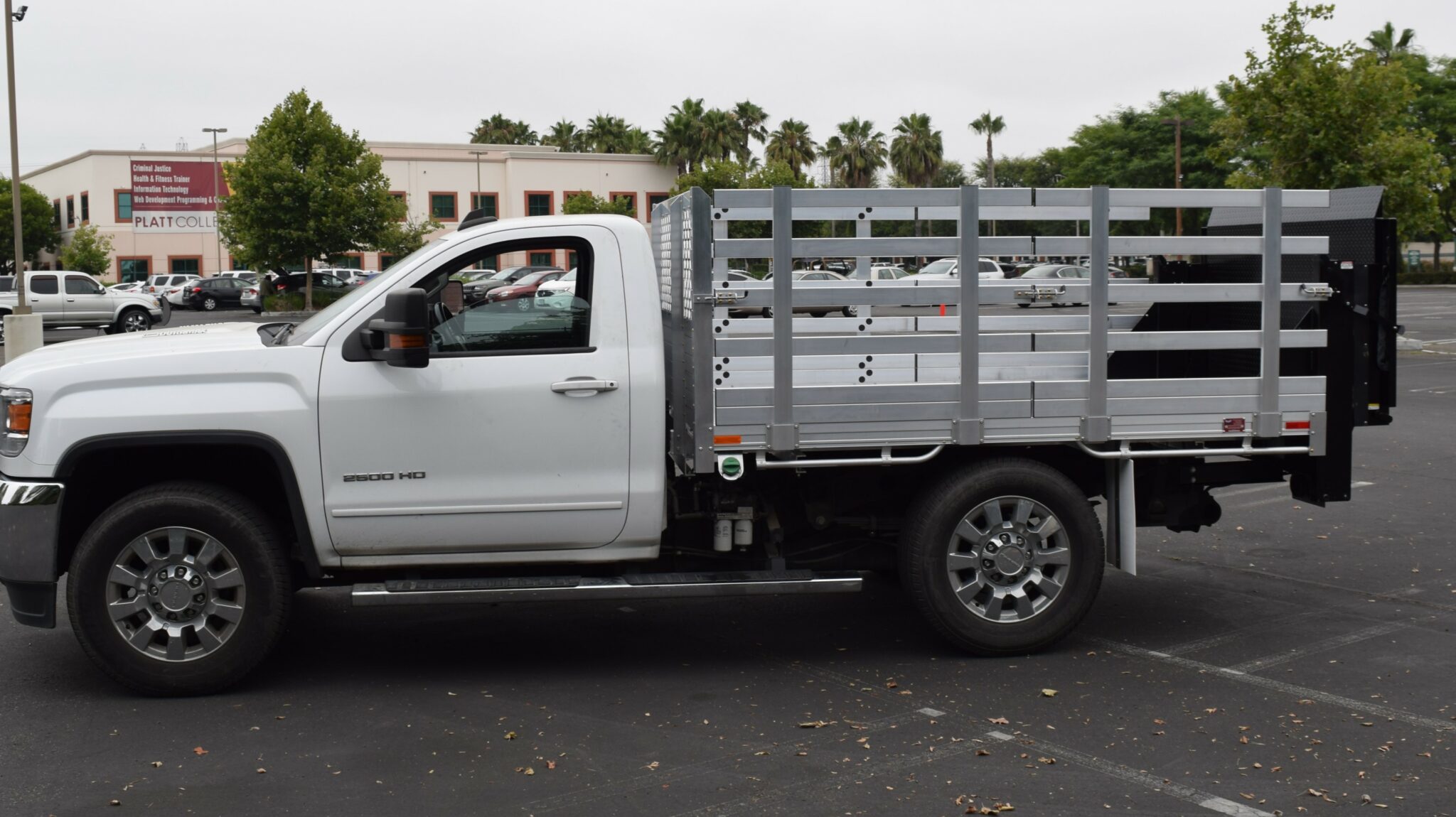 2016 GMC Sierra 2500, 6'6'' X 9' Aluminum Stake Bed with 38'' lift out sides, & Tommy lift gate in the rear.