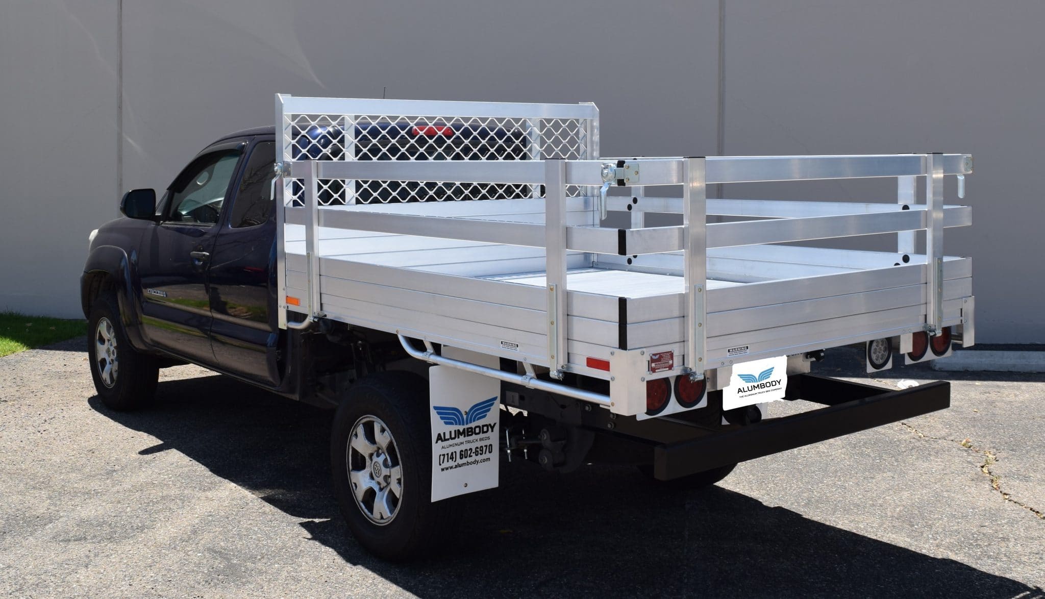2017 Toyota Tundra with a 6'6" X 7'6" AlumBody aluminum stake bed, 38" lift-out stakes, 22" fold-down rear gate, dock bumper