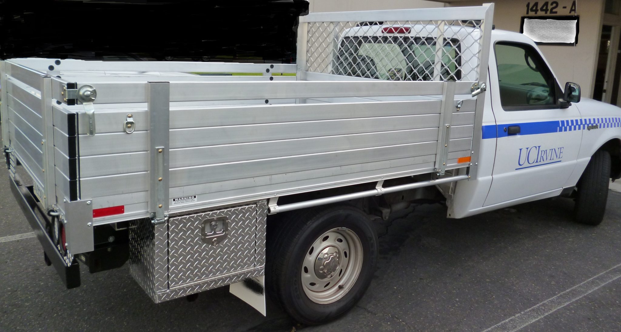 2005 Ford Ranger with a 6' X 6'6" AlumBody aluminum flat bed with custom 16" fold down gates 2 custom underbody tool boxes and dock bumper