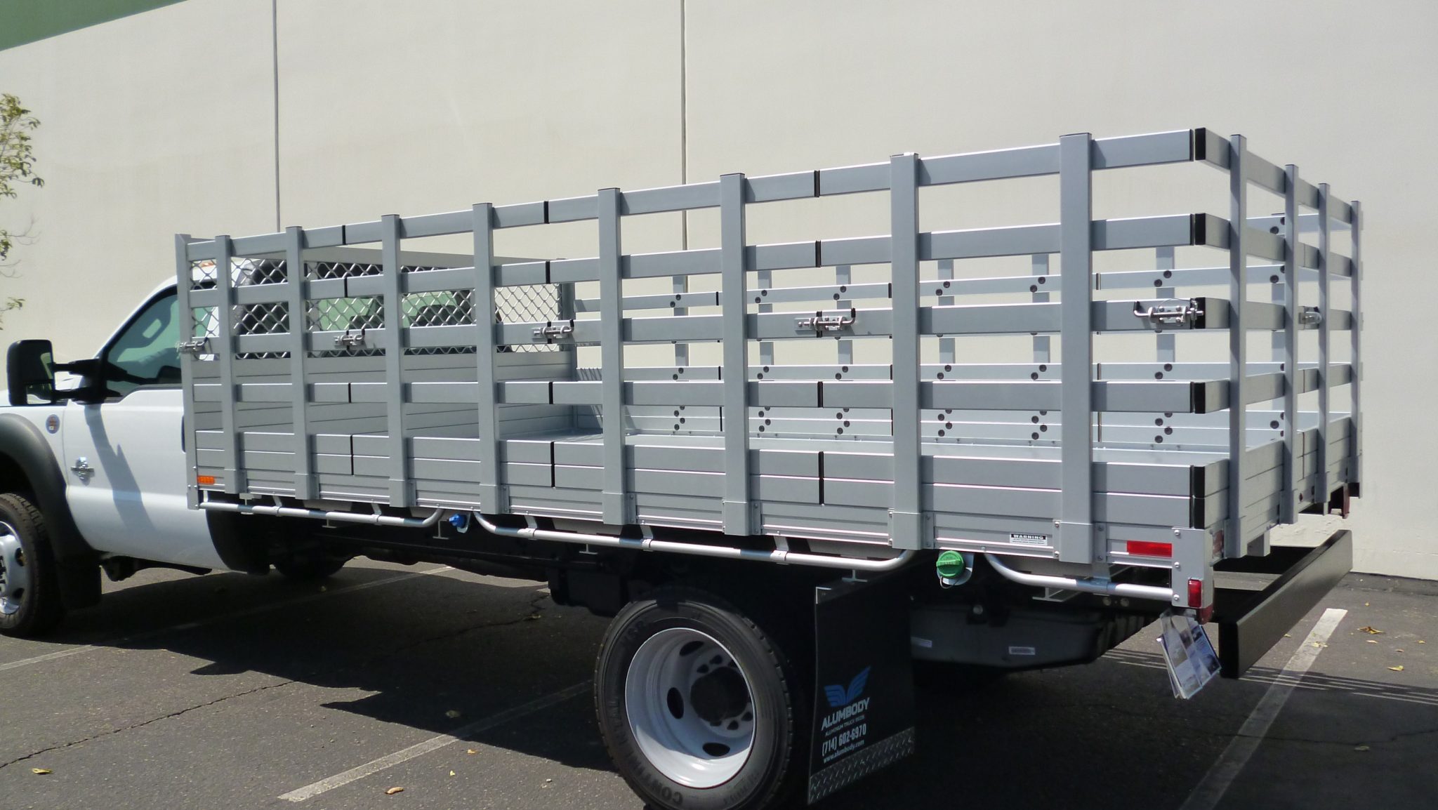 2015 Ford F550 Dual Rear Wheel with an 8' X 14' AlumBody aluminum stake bed with 38" lift out stakes and dock bumper