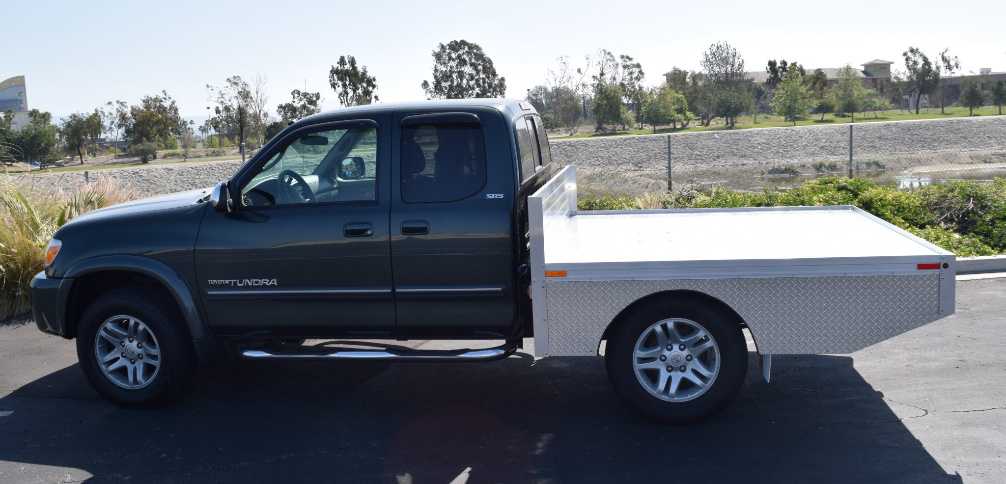 2006 Toyota Tundra with a custom 6'6" × 7' AlumBody aluminum flat bed for a pop-up camper