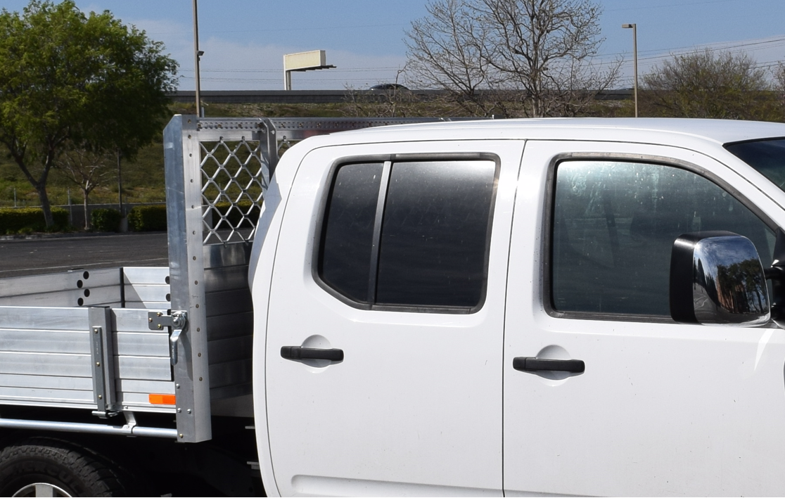2008 Nissan Frontier with a 66×66 aluminum body with 9" solid fold-down gates, a reinforced headboard and aluminum L-track