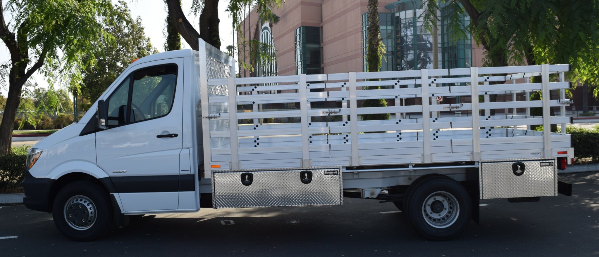Mercedes-Benz Sprinter 7’6” x 14’ aluminum stake bed with 38″ lift-out stakes, 4 underbody tool boxes (two 18”X18”X60”, two 18”X18”X36”), and dock bumper