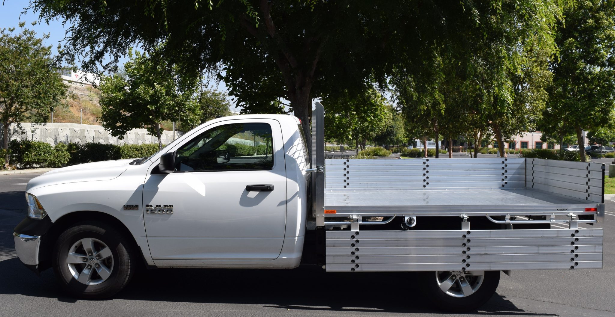 2014 Ram 1500 with a 6'6" X 9' AlumBody aluminum flat bed with 15" fold down gates using the factory bumper