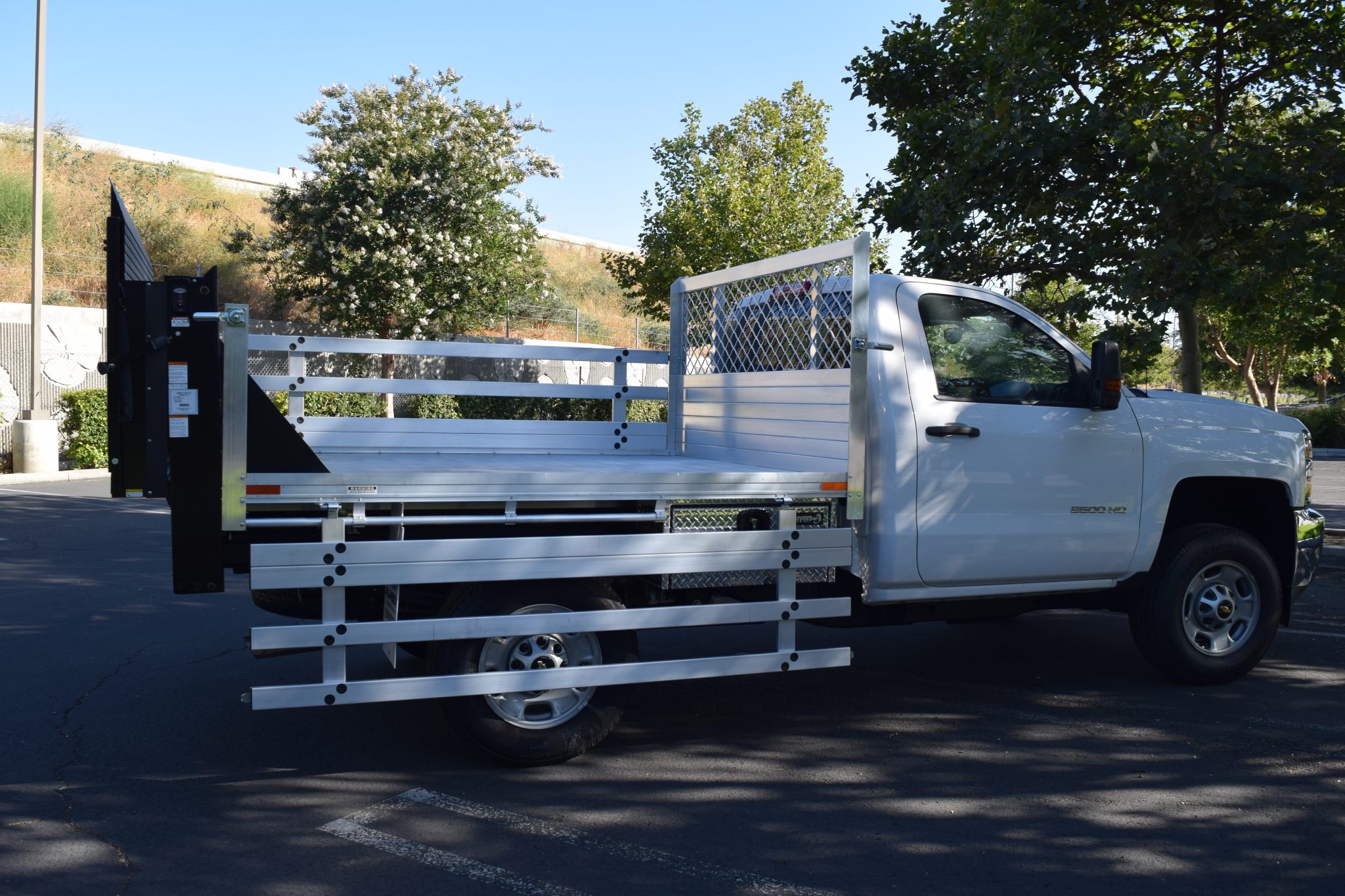 2017 Chevy Silverado 2500 with a 66" × 7' AlumBody aluminum flat bed with 22" fold-down gates, 2 underbody tool boxes and Tommygate lift gate