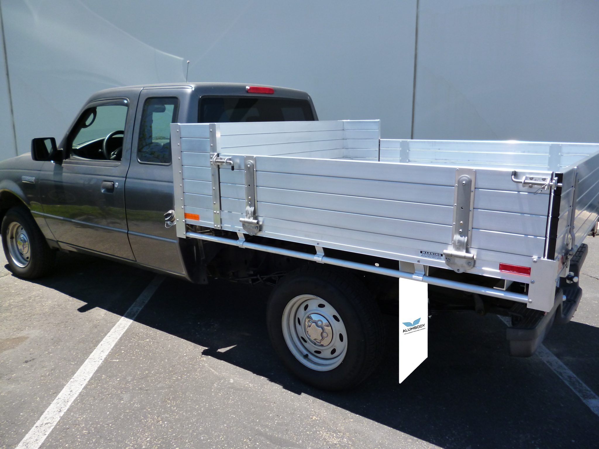 2008 Ford Ranger with custom 6' × 6'6" AlumBody aluminum flat bed with 12" fold-down gates using the factory bumper