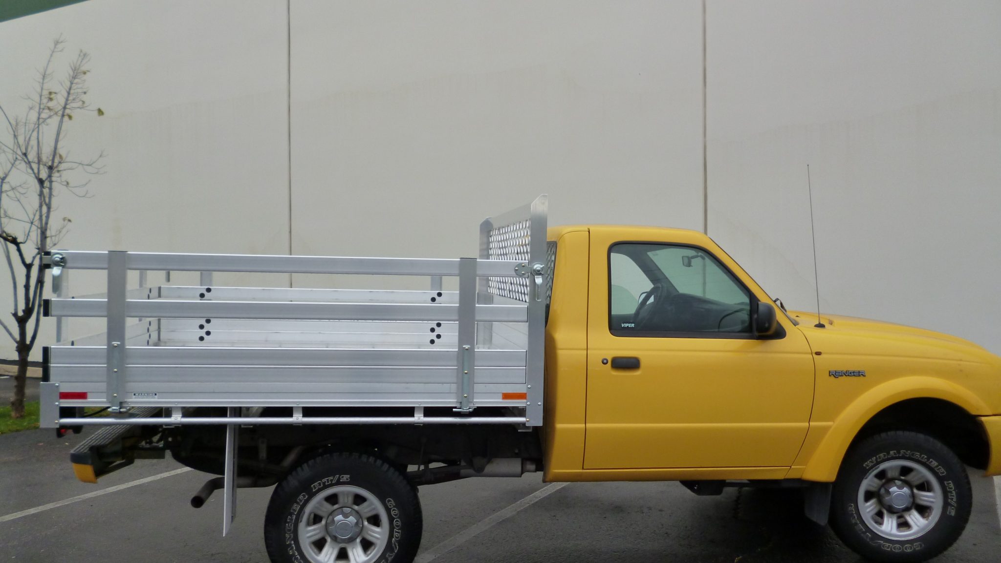 2010 Ford Ranger with a 6' X 6'6" AlumBody aluminum flat bed with 22" fold down gates using the factory bumper