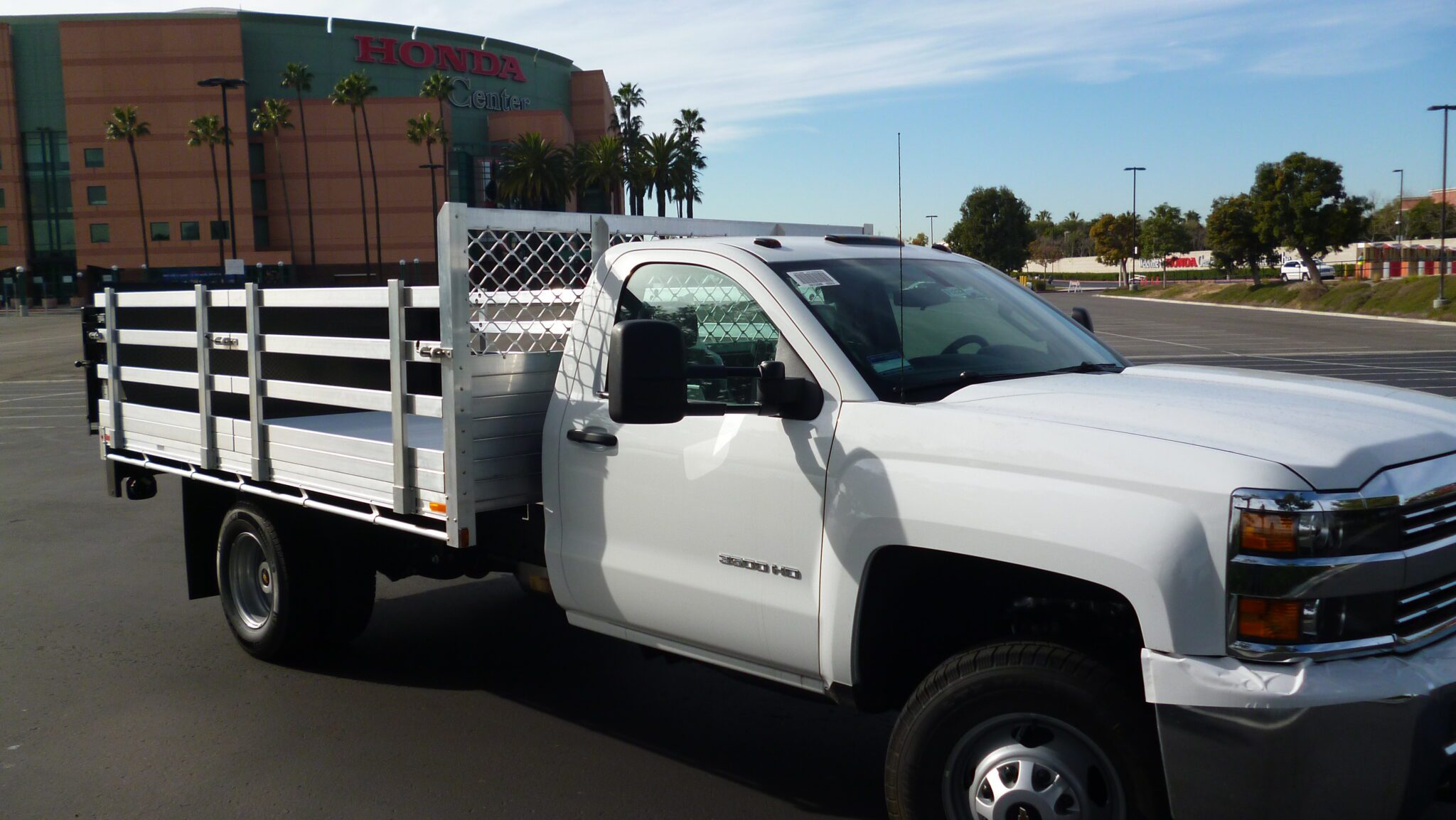 2015 Chevy 3500 with an 8 X 12 aluminum stake bed 30 lift out stakes a Tommy lift gate in the rear.