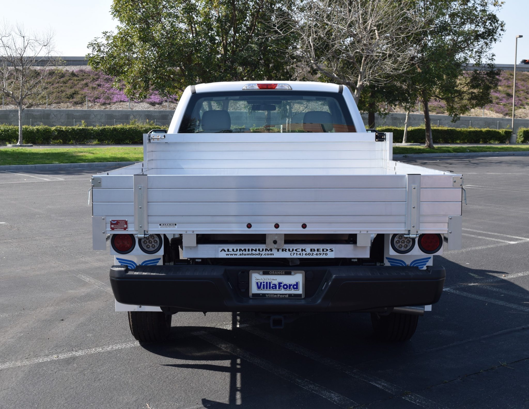 2019 Ford F150 with an 81" × 8' AlumBody aluminum pool truck bed with 9" solid fold-down gates using stainless steel hardware and the factory bumper