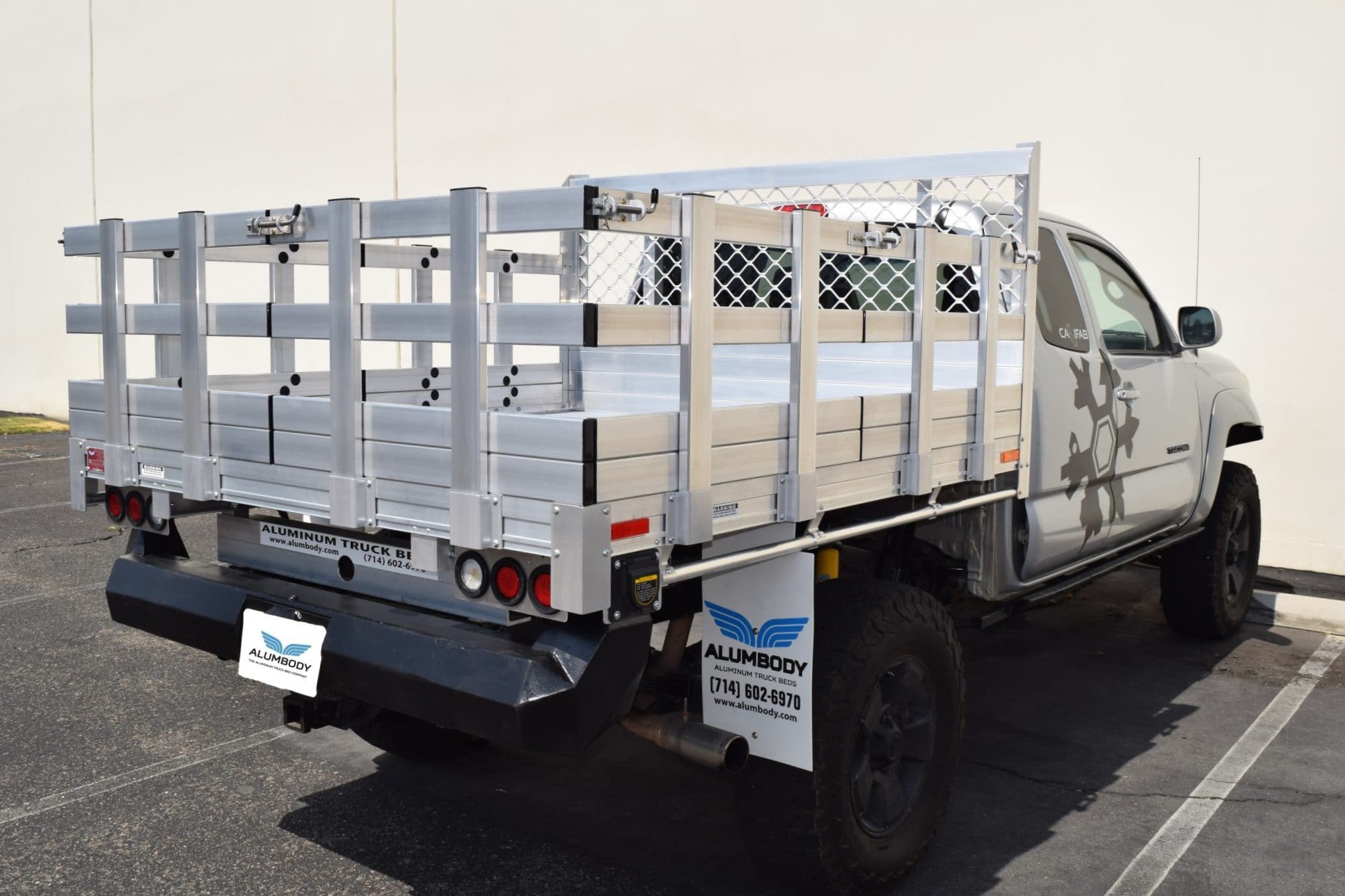2013 Toyota Tundra with a 6'6" X 9' AlumBody aluminum flat bed, 22" fold-down gates using the factory bumper