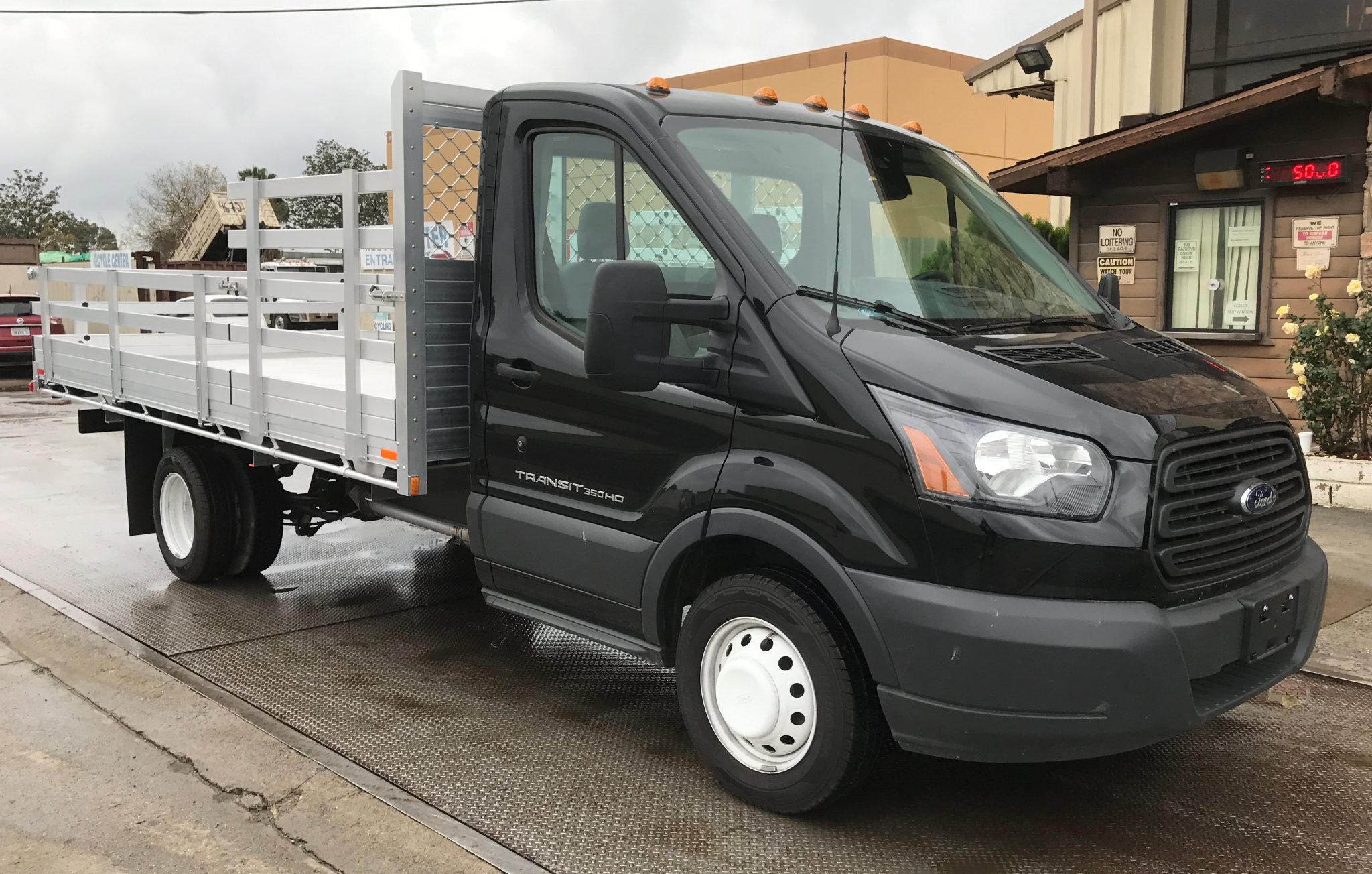 2016 Ford Transit 350HD Dual Rear Wheel with a 7'6" X 14' AlumBody aluminum stake bed with 38" lift out stakes and 22" fold down gates using a dock bumper passenger