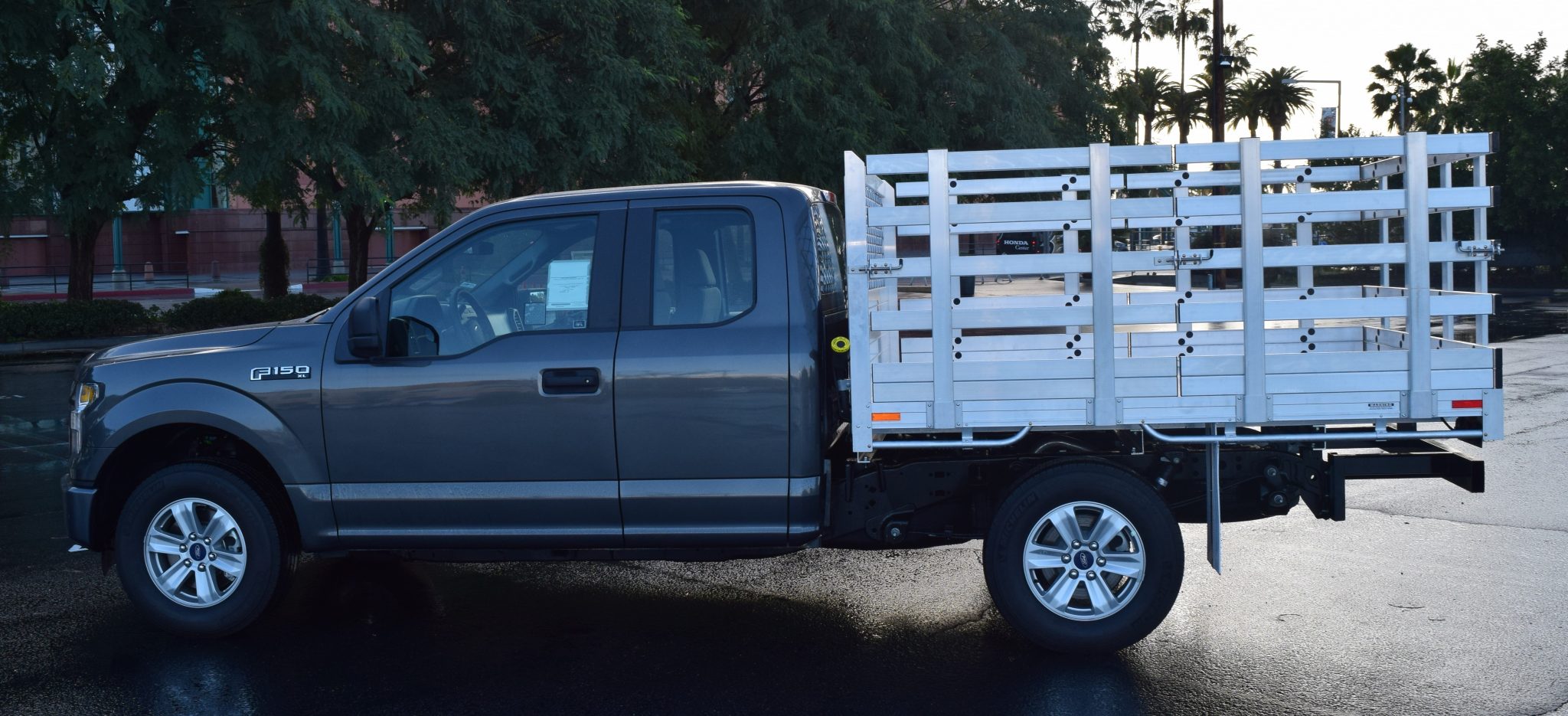 2016 Ford F150 with a 6'6" X 7'6" AlumBody aluminum stake bed with 38" lift out stakes and dock bumper
