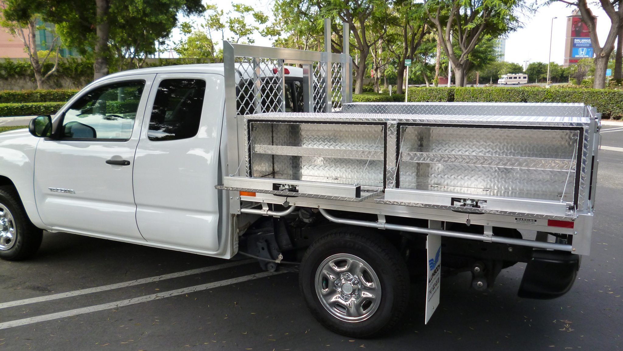 Toyota Tacoma with a 6’ X 7’ AlumBody aluminum flat bed with 2 topsider tool boxes 16” X 13” X 72” with custom shelves
