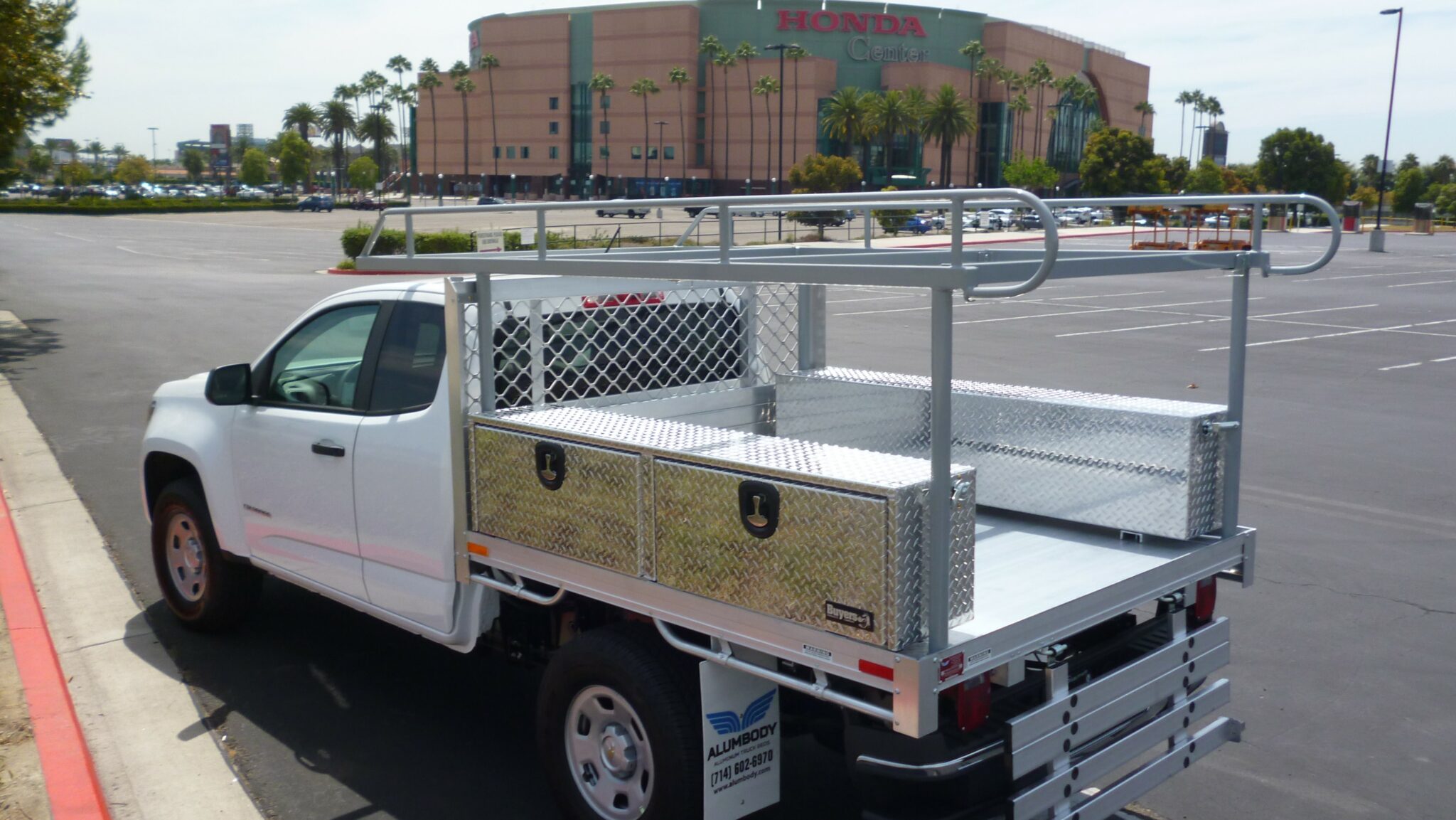 2015 Chevy Colorado with a 6x66 aluminum body 2 overbody toolboxes 16x13x72 and a 16 rear fold down gate ladder rack using the factory bumper