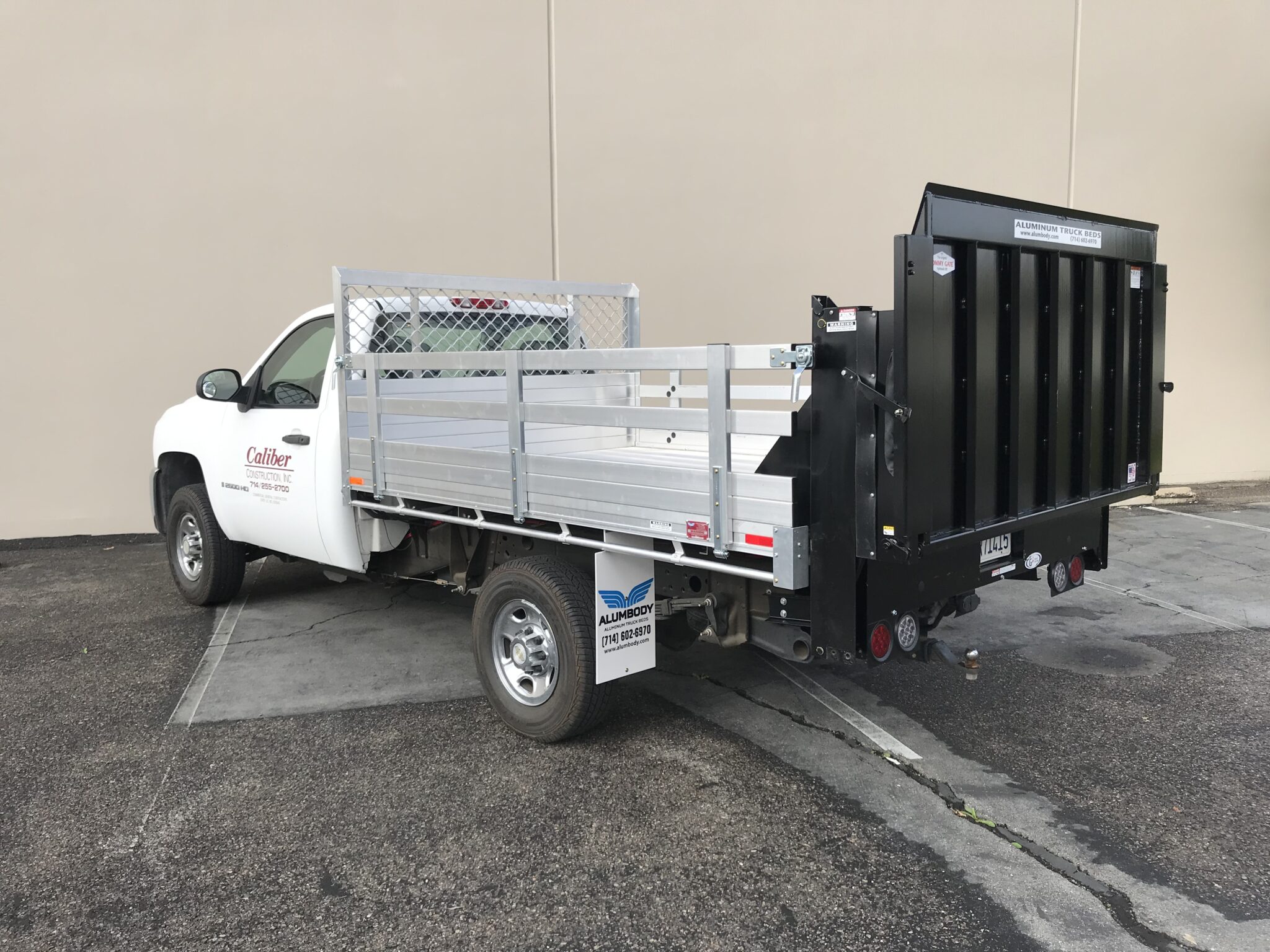 2007 Chevy Silverado 2500 66×9 aluminum flatbed with 22" fold-down sides, Tommy lift gate in the rear