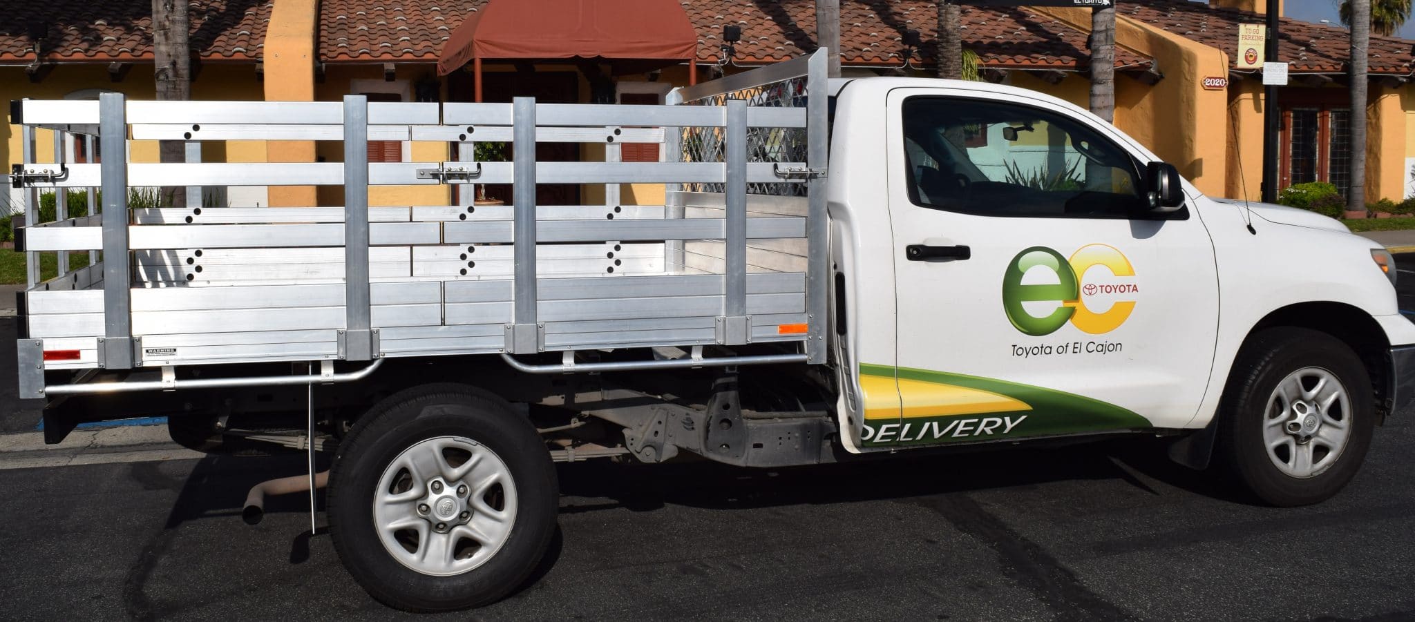 2015 Toyota Tacoma with a 6'X7' AlumBody stake bed with 30" lift-out sides, 22" fold-down rear gate, and dock bumper