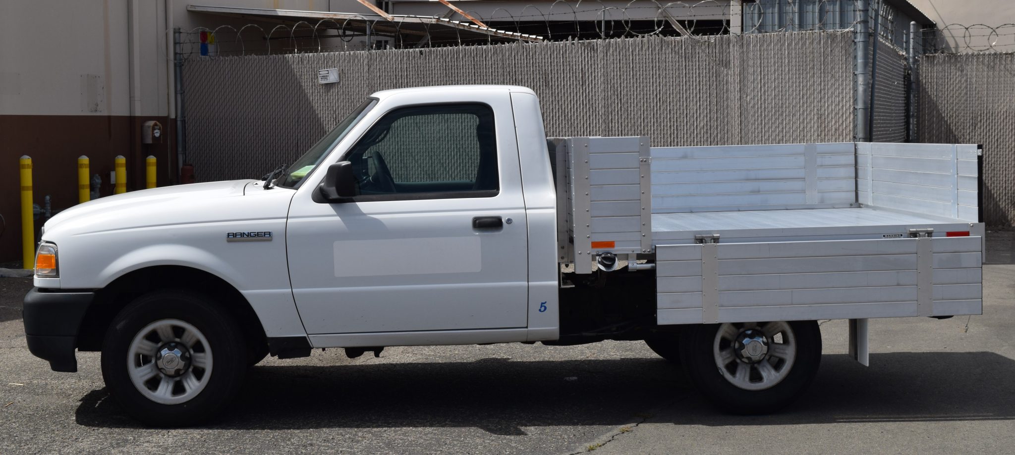 2008 Ford Ranger with a 6' X 6'6" AlumBody aluminum flat bed with 15" solid fold down gates no mesh headboard and dock bumper