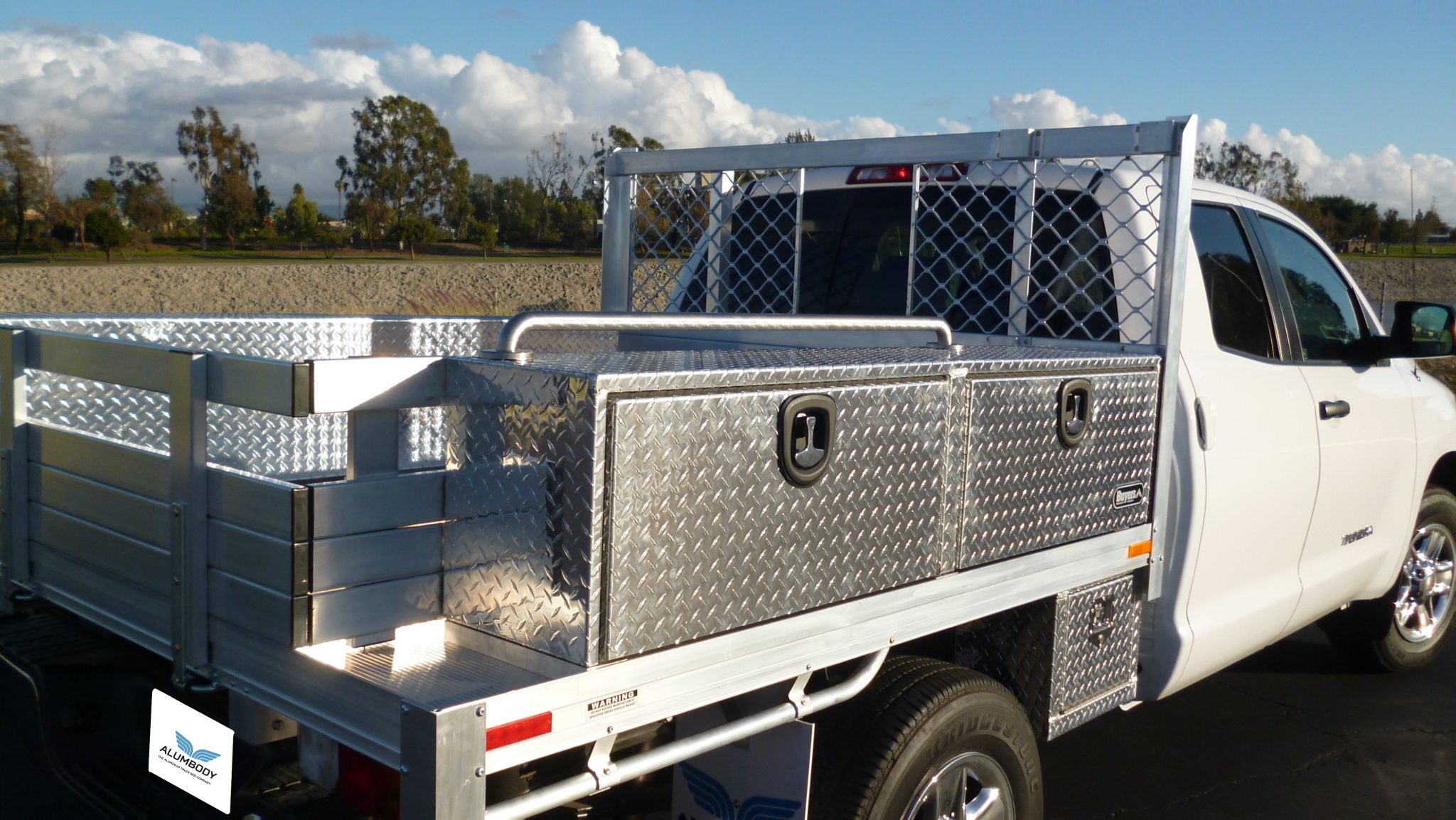 2014 Toyota Tundra with a 6'6" × 7' AlumBody aluminum flat bed, 2 topsider tool boxes, 2 custom underbody tool boxes, vise mount area and removable PVC pipe rack