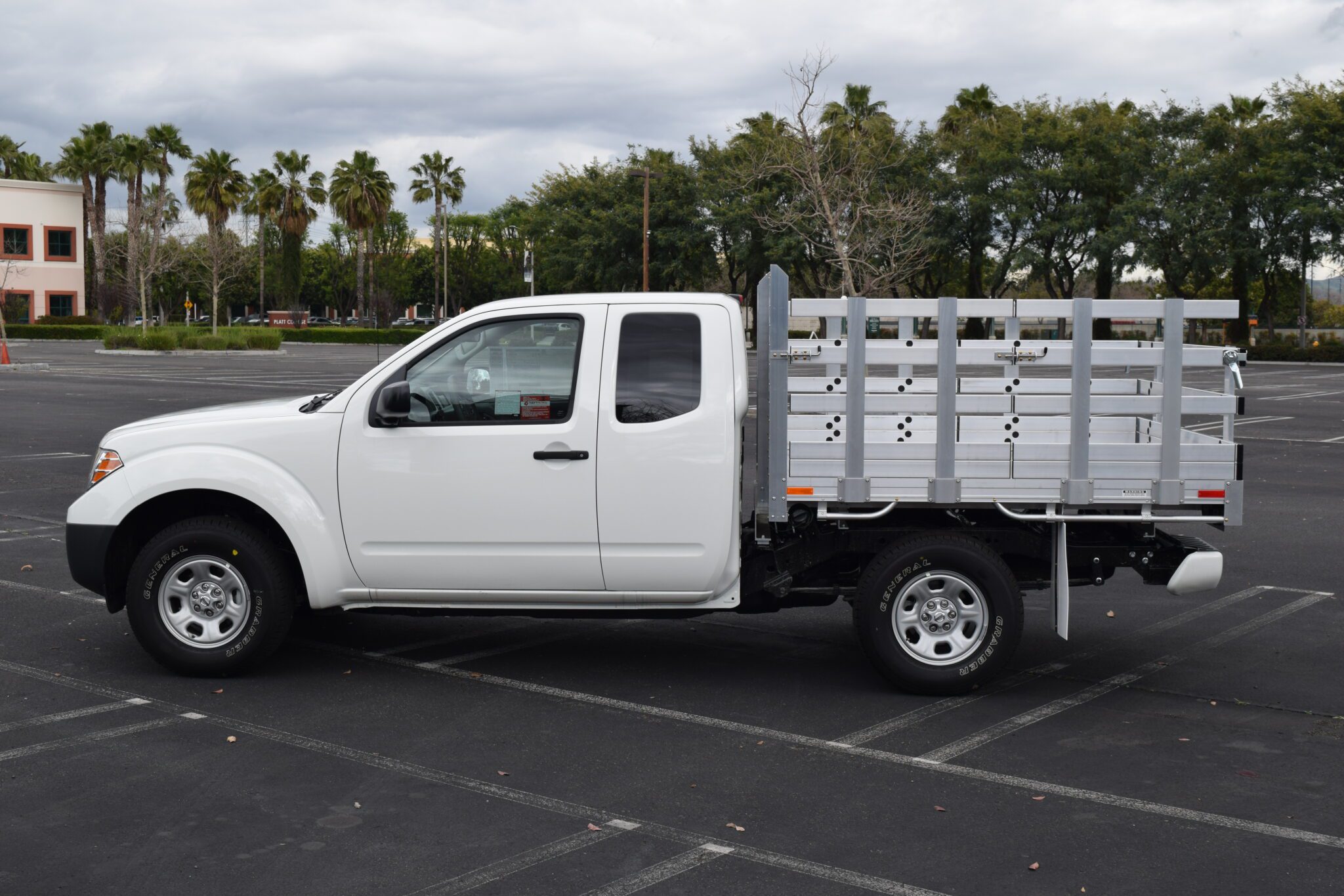 2019 Nissan Frontier 6'x6'6'', aluminum stake bed with 22'' lift out stakes using the factory bumper