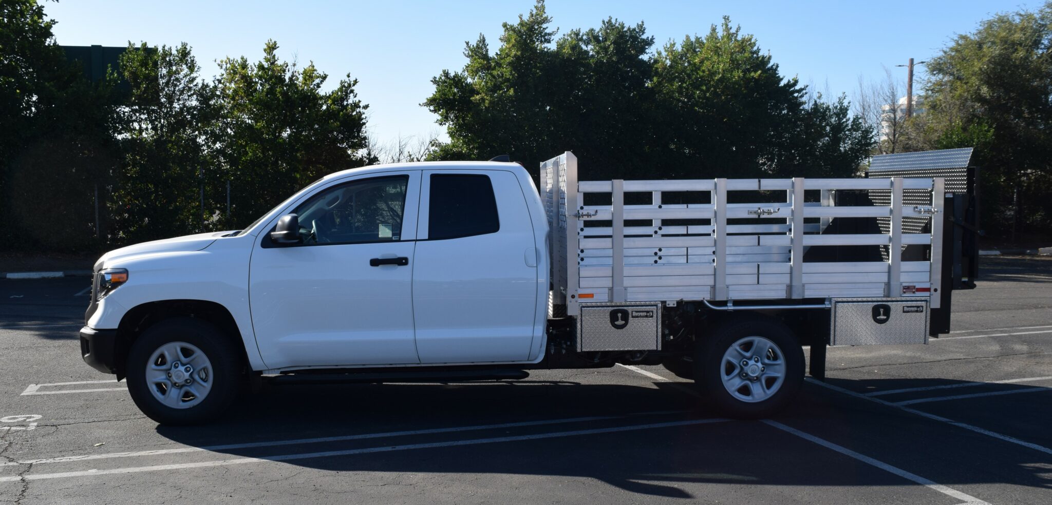 2021 Toyota Tundra 7’x9’ aluminum stake bed with 30″ lift-out sides, liftgate in the rear, and 4 tool boxes (two 14”x12”x30” and two 14”x12”x24”)