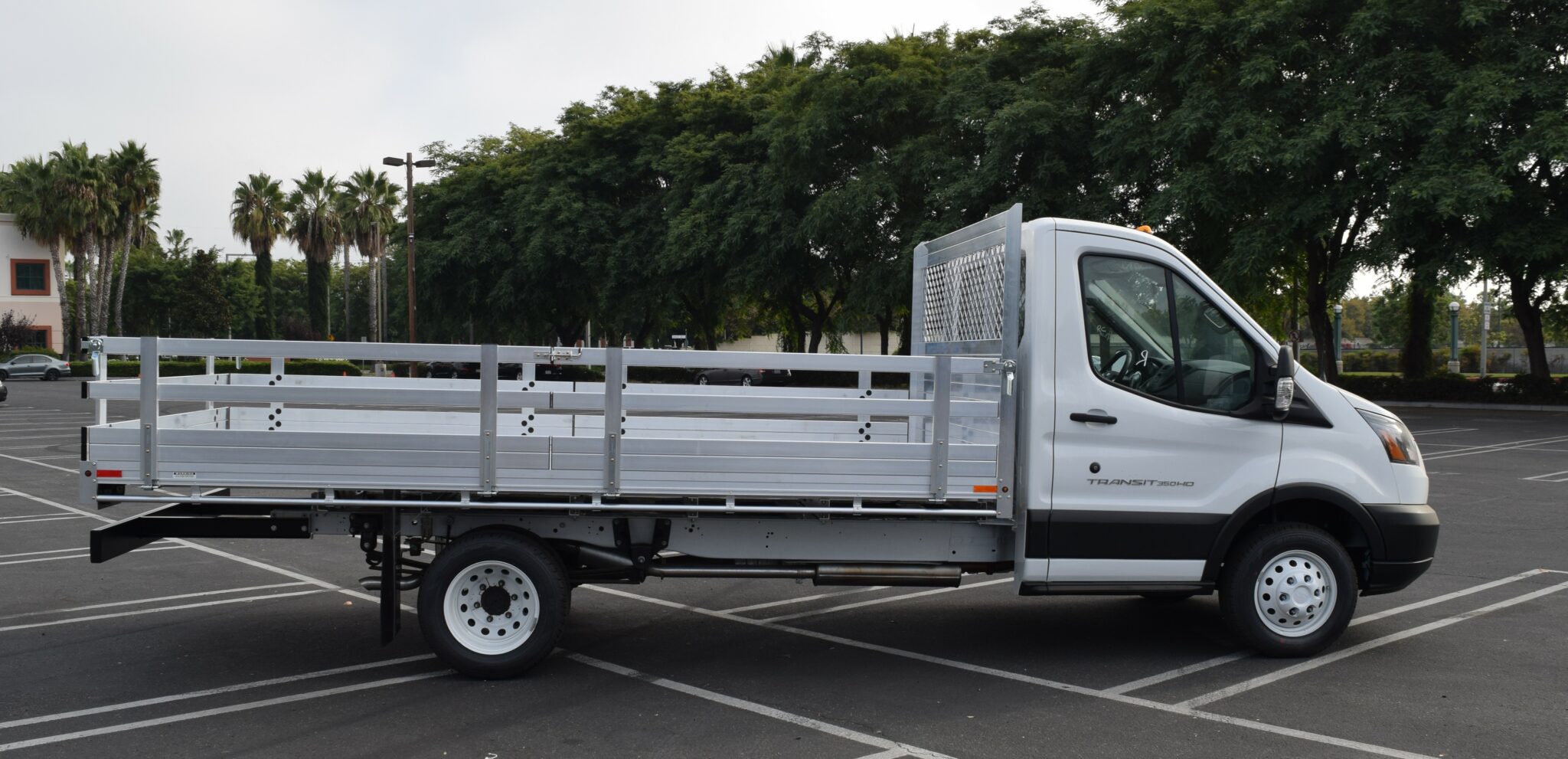 2019 Ford Transit 76x14 aluminum flatbed with 22 fold down gates and dock bumper