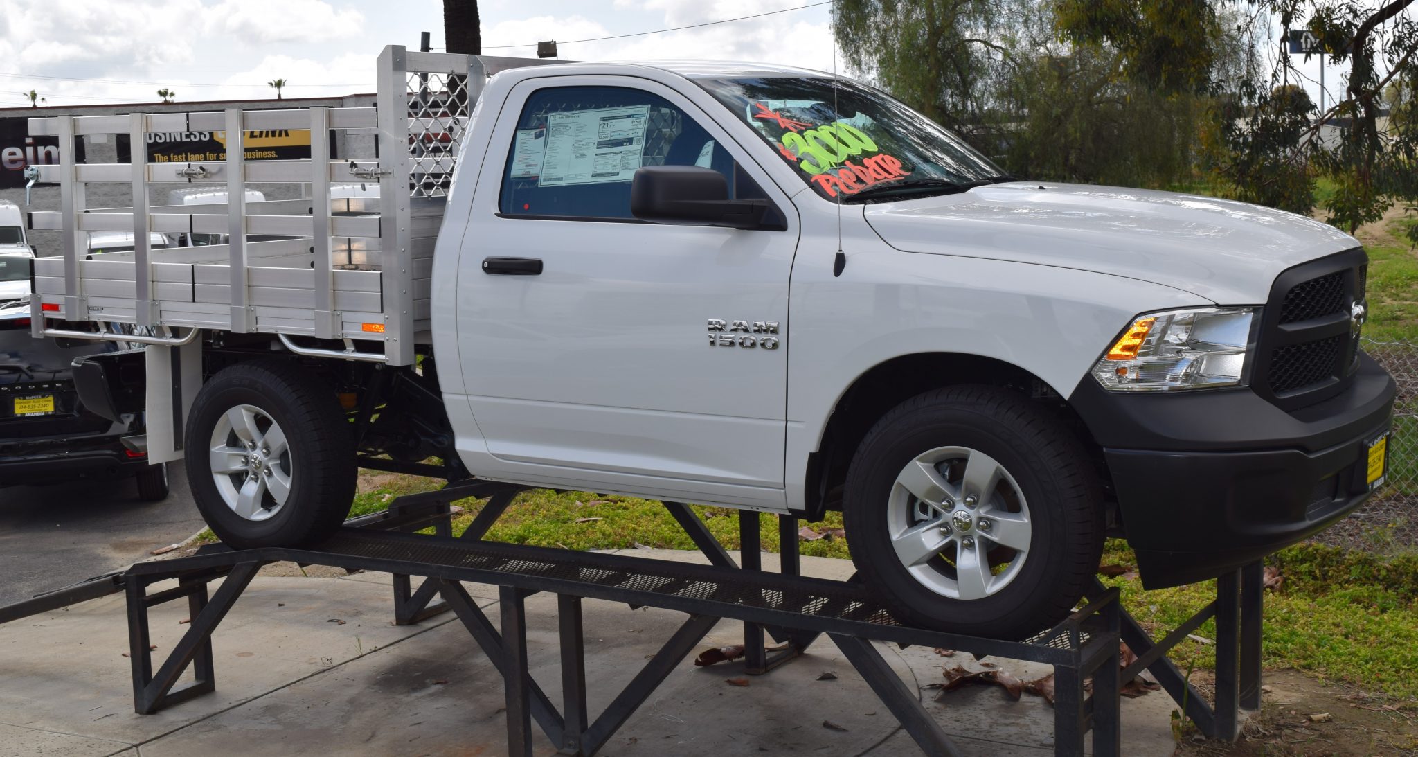 2015 Ram 1500 with a 6'6" X 7' AlumBody aluminum stake bed with 30" lift out stakes using the factory bumper