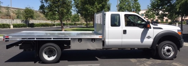 Ford F550 Dual Rear Wheel with an 8’ X 12’ AlumBody aluminum flat bed, underbody tool box 18” X 18” X 48”, and dock bumper