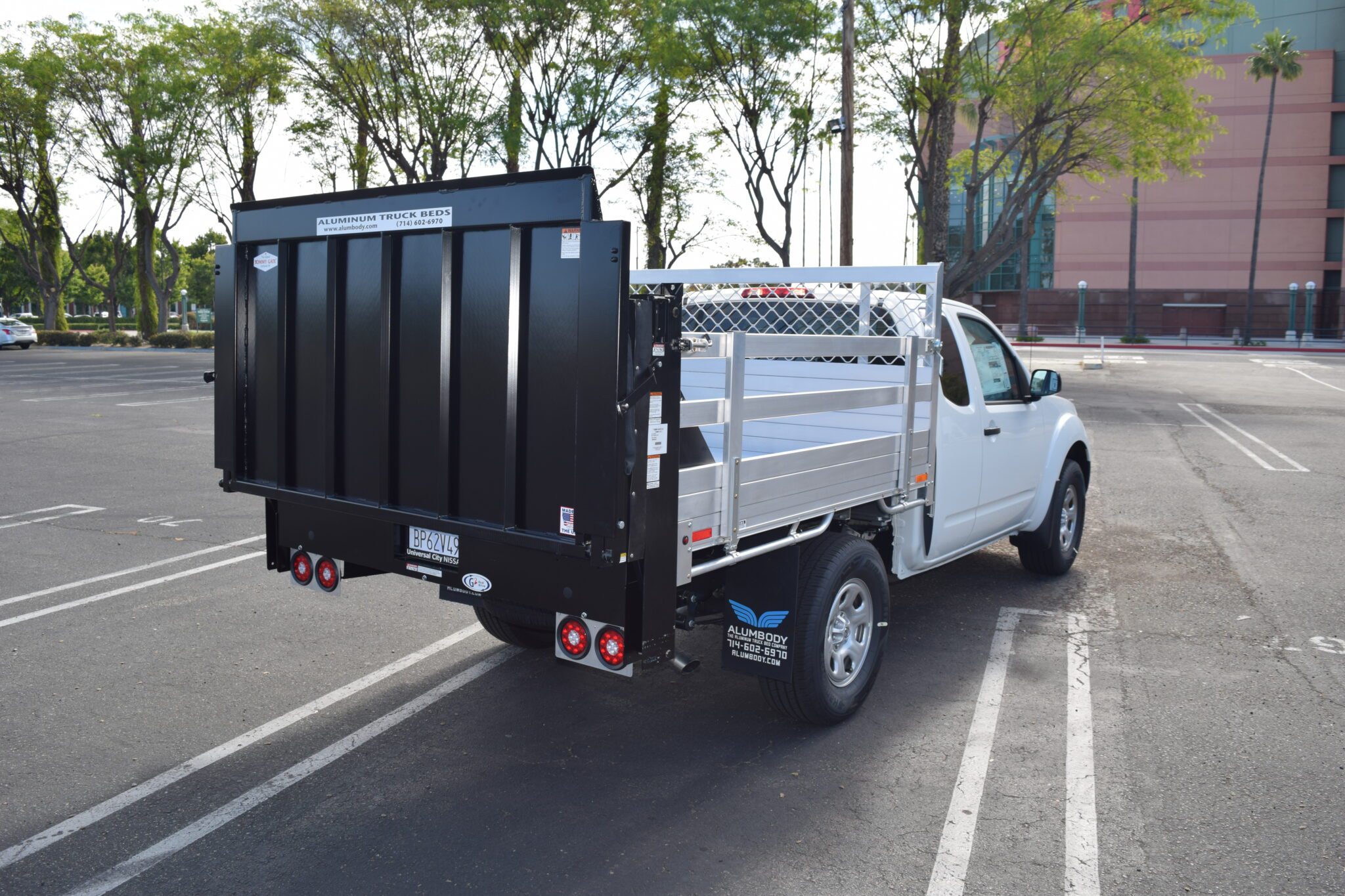 2020 Nissan Frontier 6×66 aluminum flat bed with 22" fold-down sides and lift gate in the rear