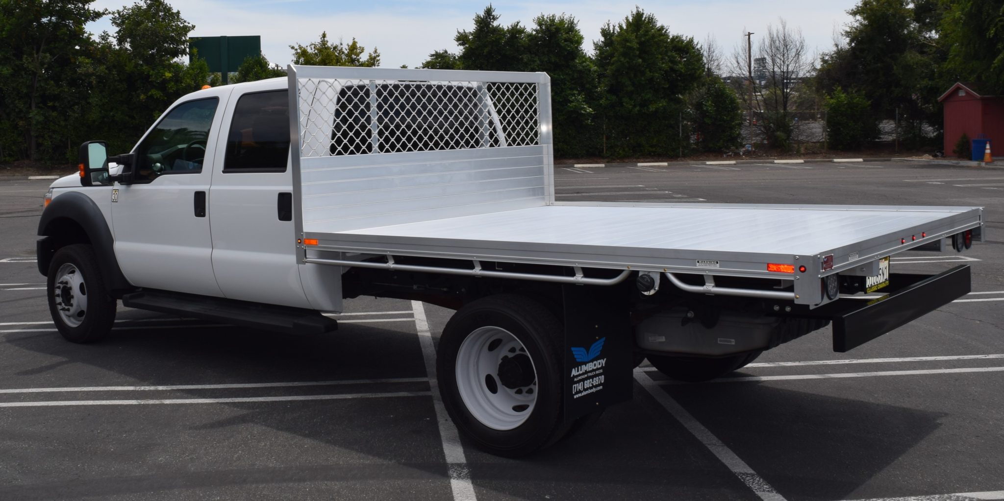 2016 Ford F550 Dual Rear Wheel with an 8' X 10' AlumBody aluminum flat bed and dock bumper