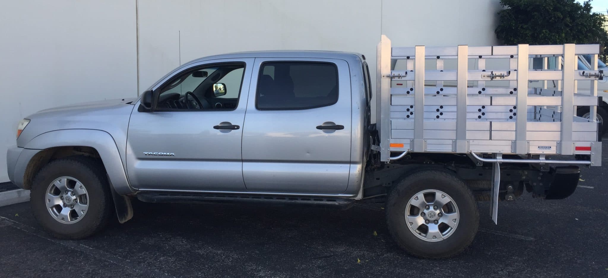 2012 Toyota Tundra with a 6'6" X 9' AlumBody aluminum stake bed, 30" lift-out stakes and dock bumper