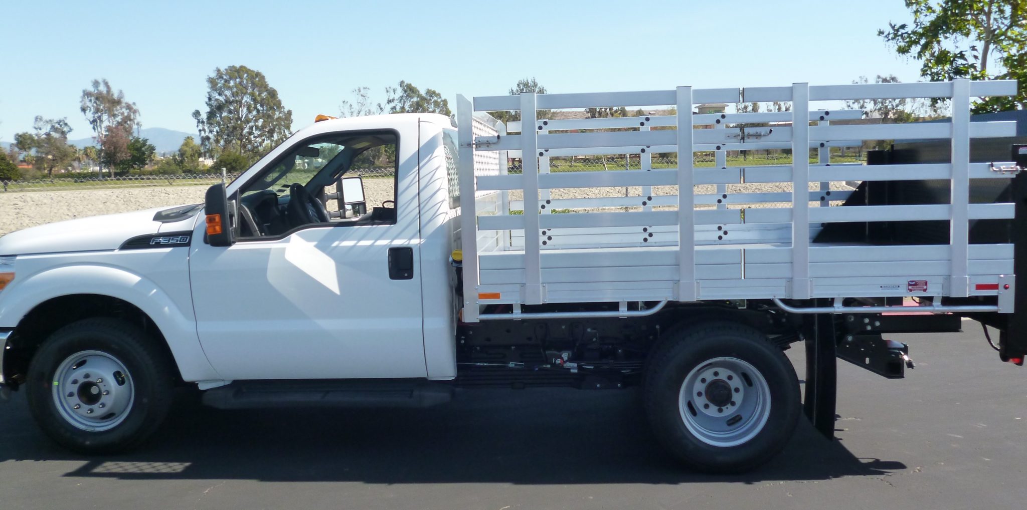 2015 Ford F350 Dual Rear Wheel with an 8' X 9' AlumBody aluminum stake bed with 38" lift out stakes and Tommygate lift gate