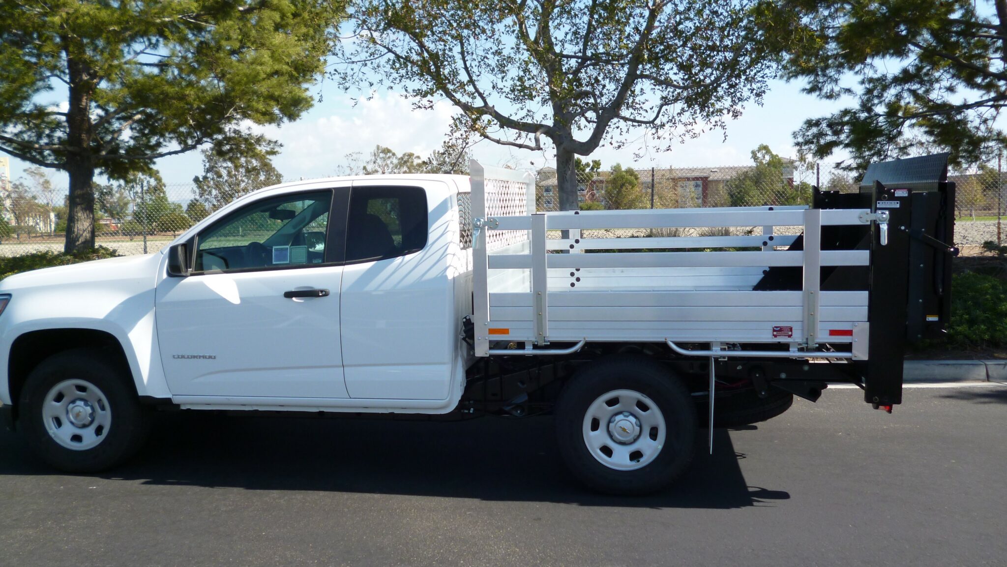 2016 Chevy Colorado aluminum flatbed with 22" fold-down sides and Tommy lift gate in the rear