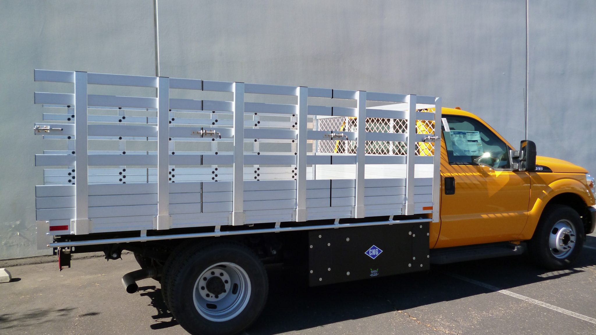 2014 Ford F350 Dual Rear Wheel with an 8' X 12' AlumBody aluminum stake bed with custom 38" lift out stakes