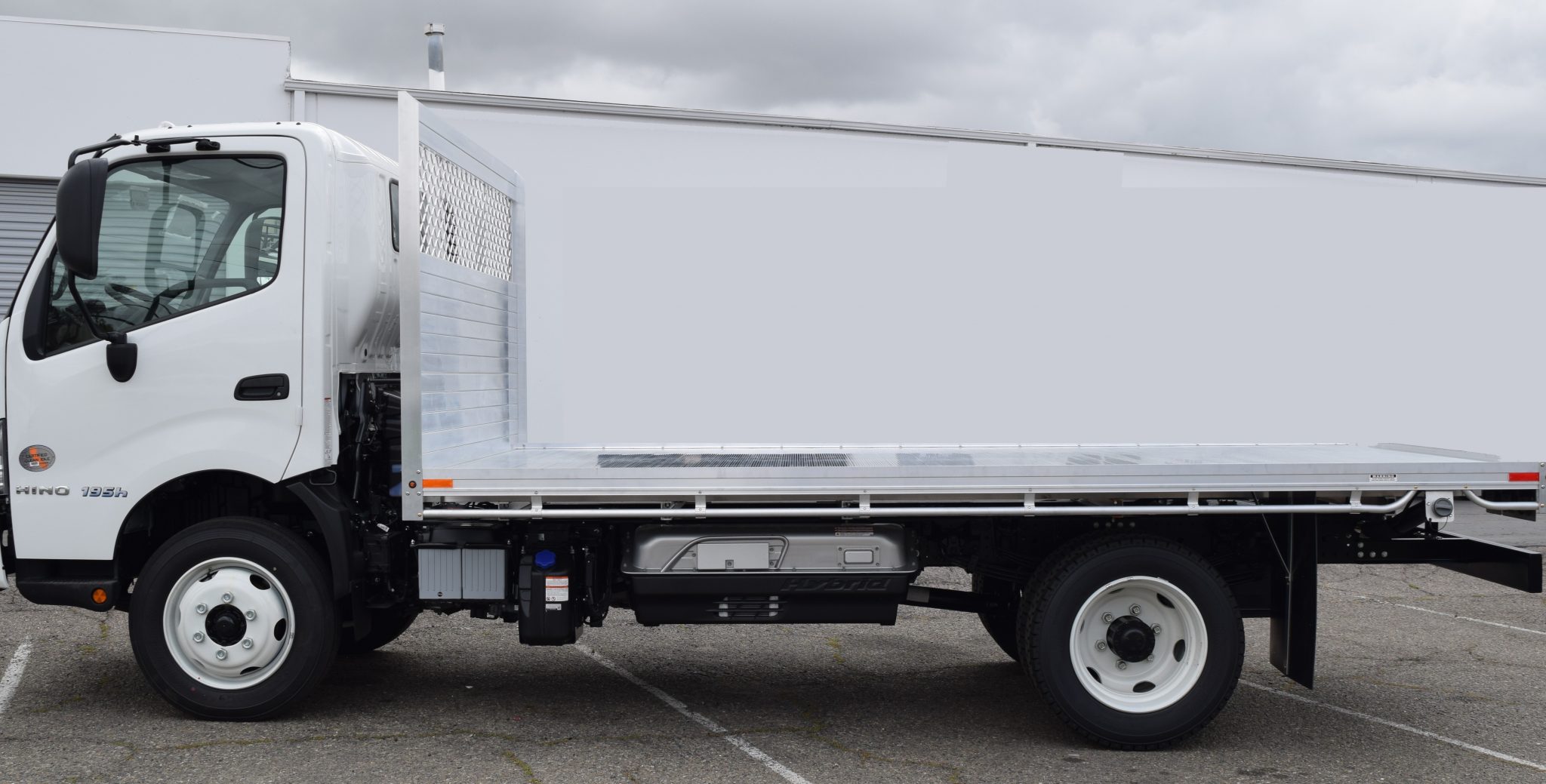 2019 Hino 195h with an 8' X 14' AlumBody aluminum flat bed with a heavy duty headboard constructed with stainless steel hardware and a dock bumper driver
