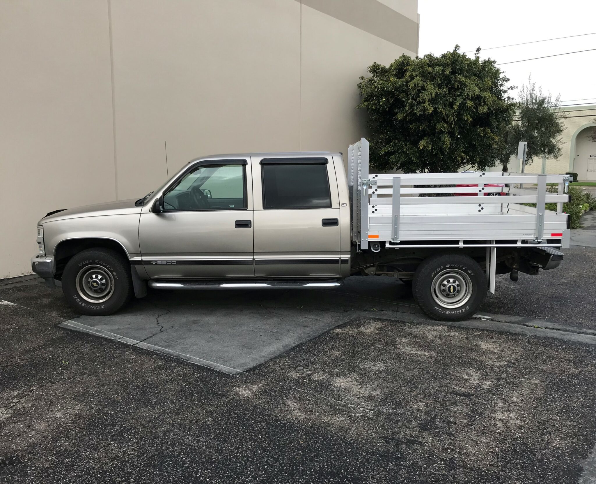 2000 Chevy 2500 66 X 7 Aluminum Stake Bed with 22 Fold Down Gates using the Factory Bumper.