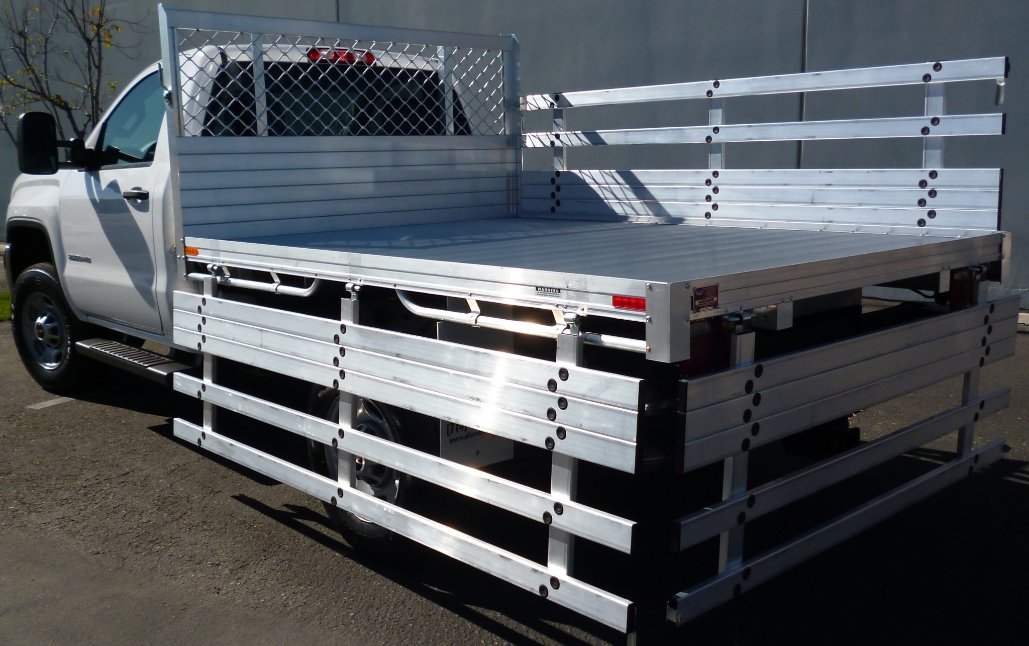 2015 GMC 2500 with a 6'6''x9' aluminum body 25'' fold down gates using the factory bumper gates
