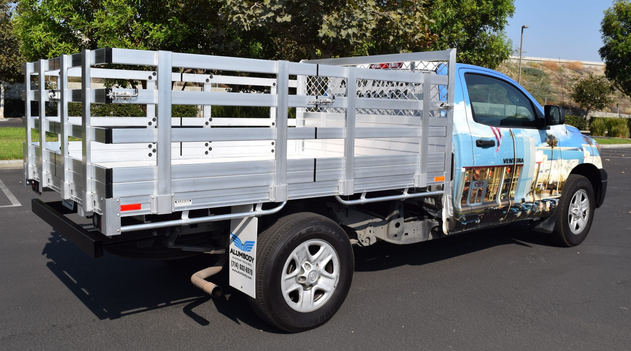 2015 Toyota Tacoma with a 6'X6'6" AlumBody flat bed, 22" fold-down gates using the factory bumper