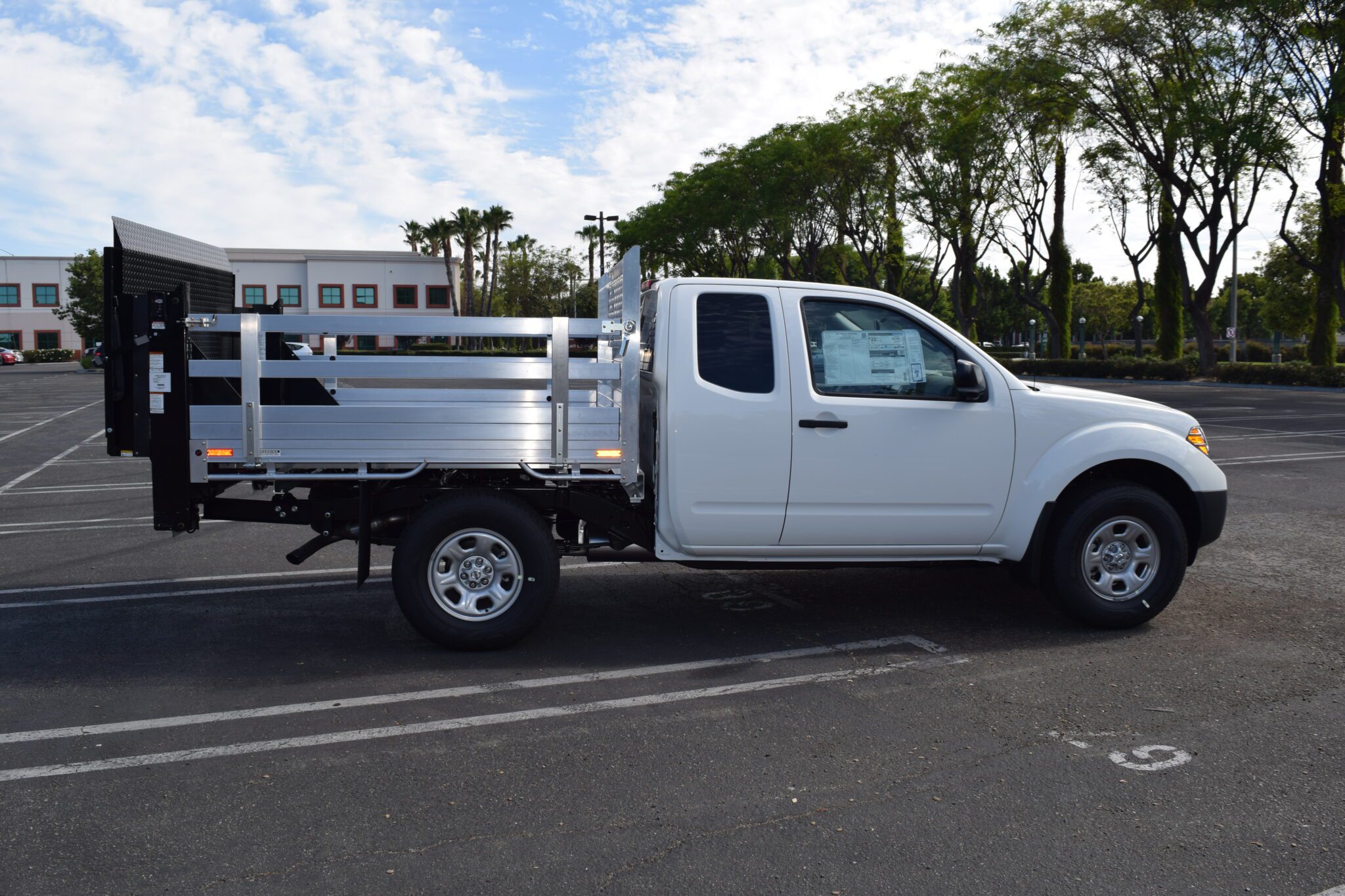 2020 Nissan Frontier 6'x6'6'', aluminum flatbed, with 22'' fold down sides and tommy lift gate in the rear