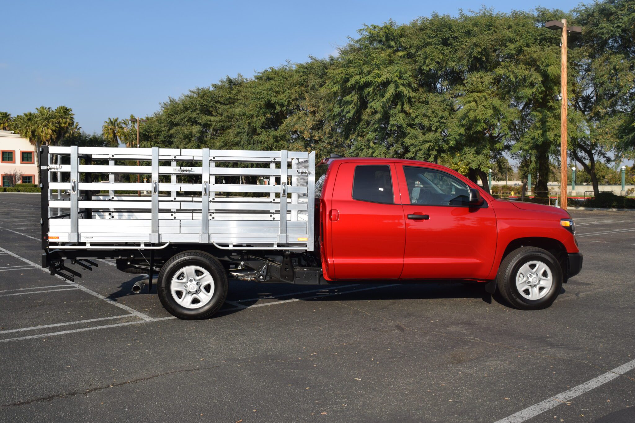 2010 Toyota Tundra with a 6'6" X 7'6" AlumBody aluminum flat bed, 30" lift-out stakes and dock bumper