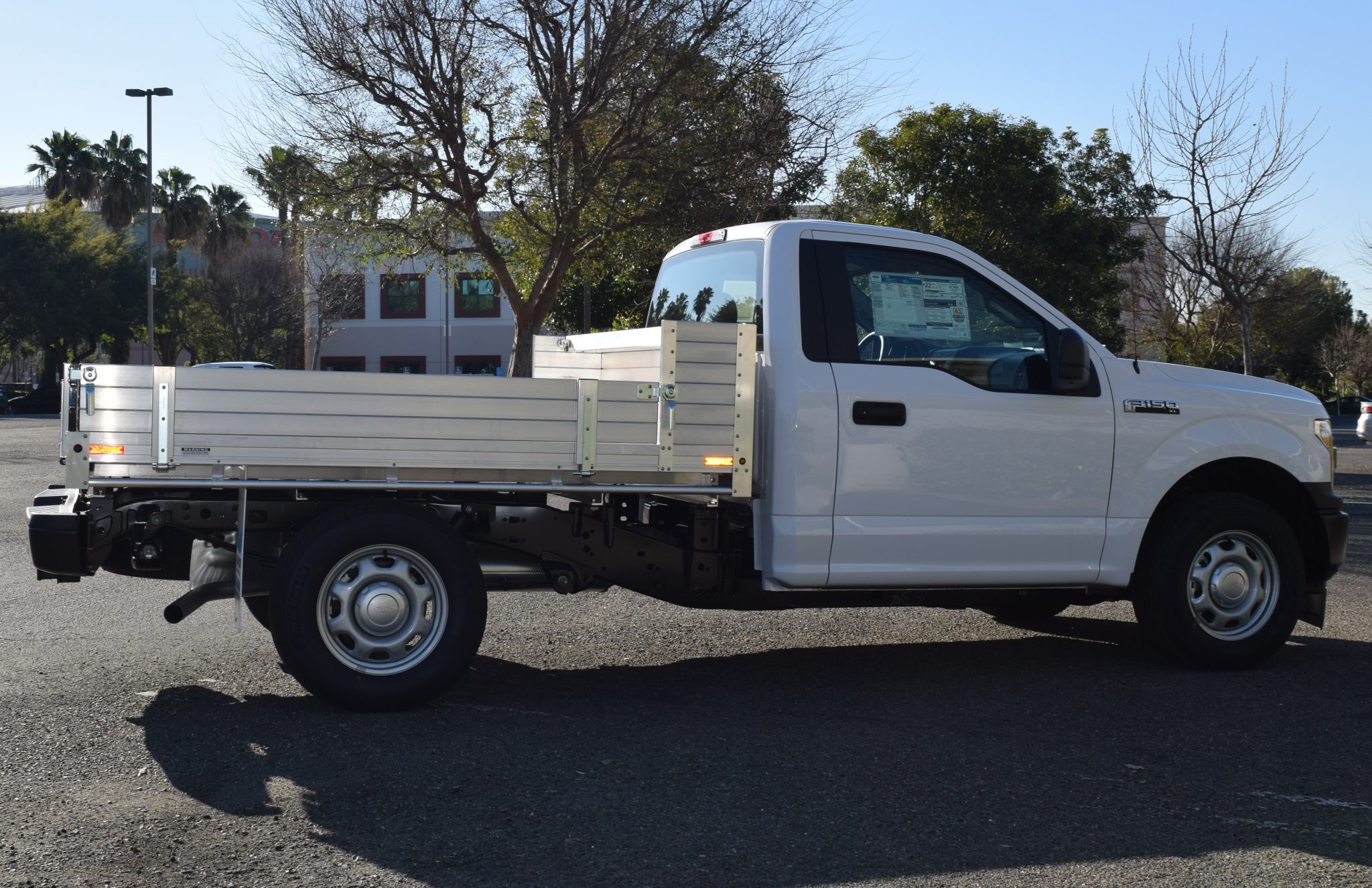 2018 Ford F150 with an 81" × 8' AlumBody aluminum pool truck bed with 9" solid fold-down gates using stainless steel hardware and the factory bumper