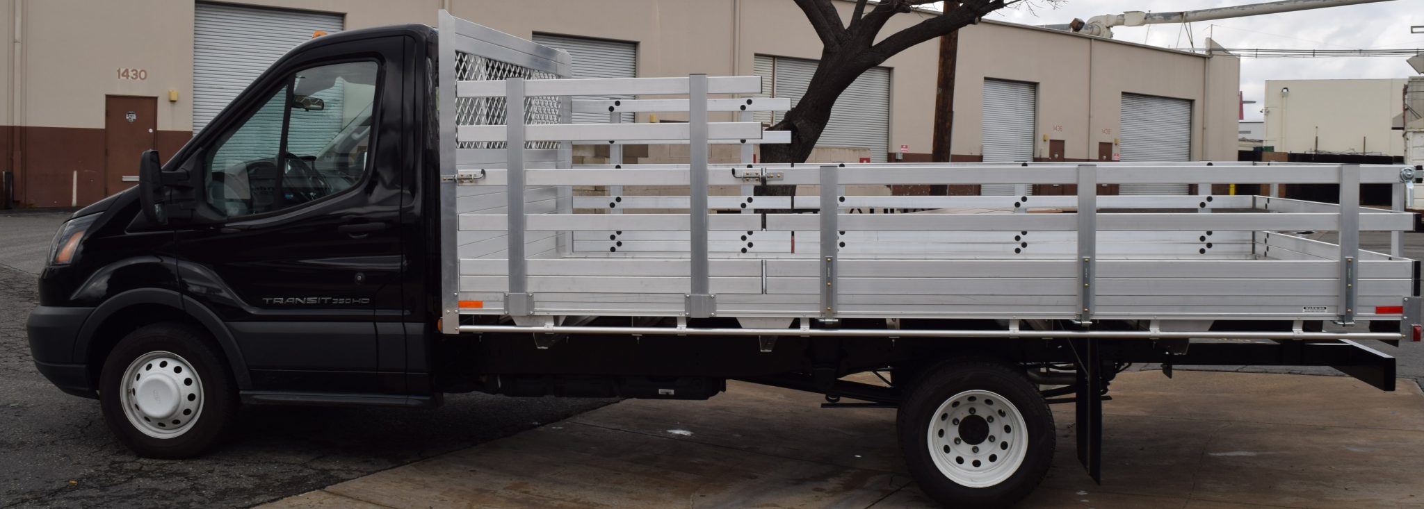 2016 Ford Transit 350HD Dual Rear Wheel with a 7'6" X 14' AlumBody aluminum stake bed with 38" lift out stakes and 22" fold down gates using a dock bumper driver