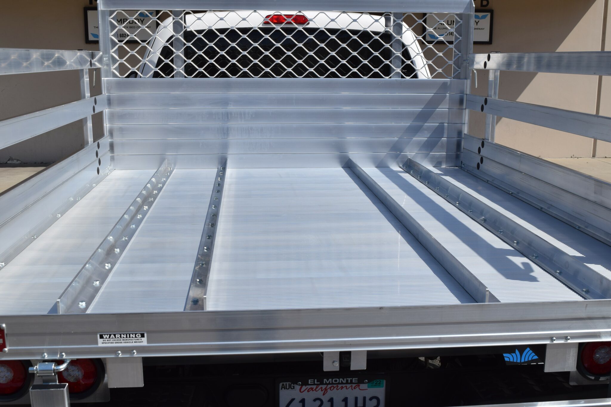 2020 Toyota Tacoma with a 6×76 aluminum body, 22" fold-down gates using the factory bumper with added wheel track in the bed