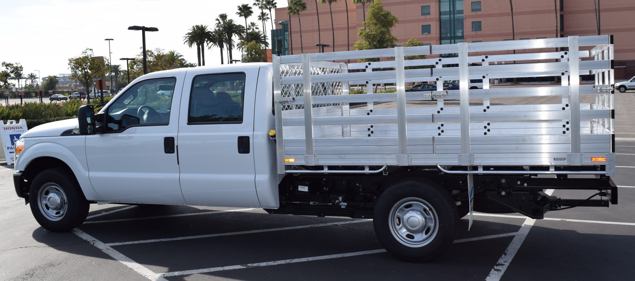 2016 Ford F350 with a 6'6" X 10' AlumBody aluminum stake bed with 38" lift out stakes and dock bumper