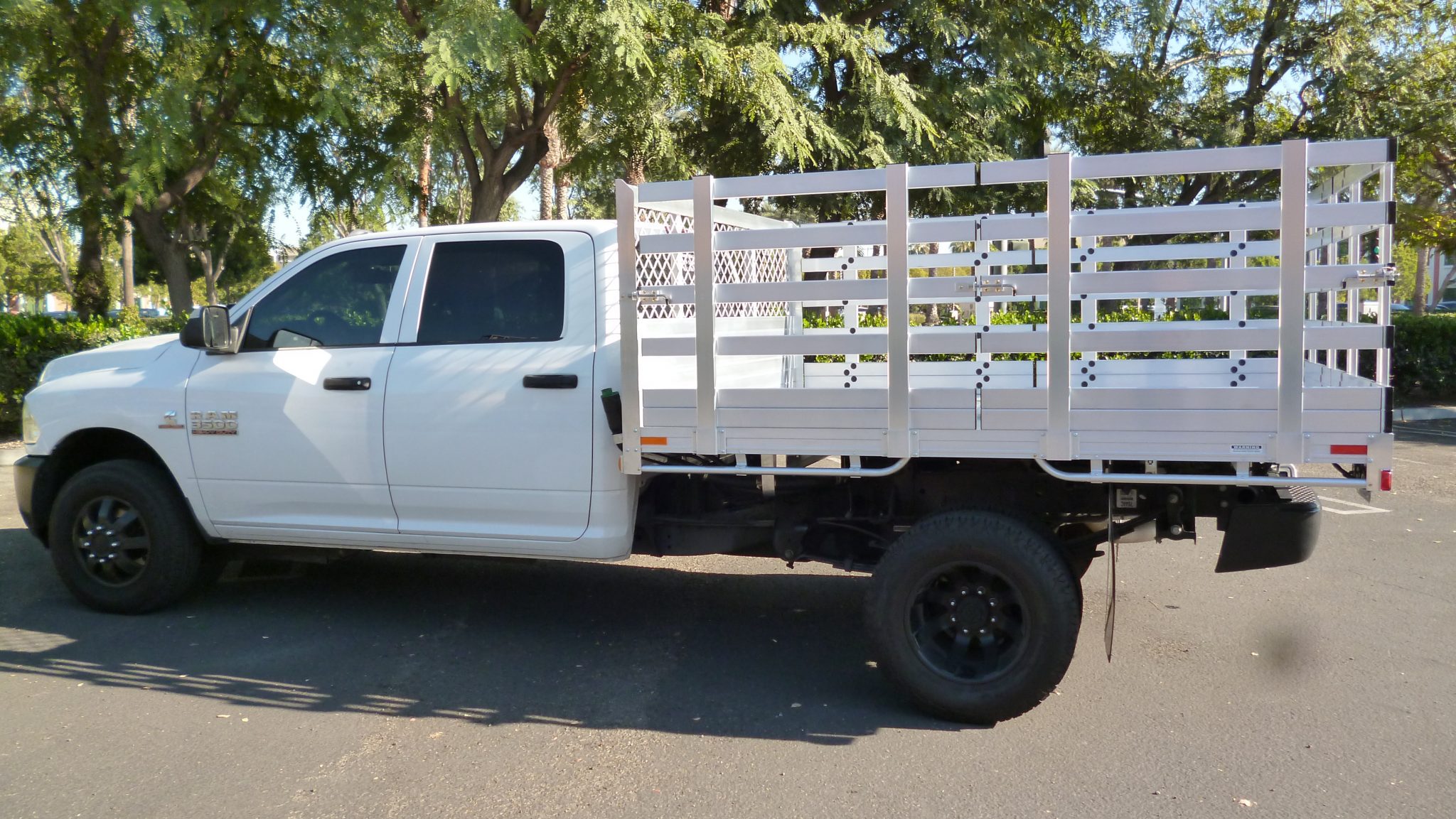 2014 Ram 3500 DRW with an 8' x 9' AlumBody aluminum stake bed with 38" lift out stakes using the factory bumper