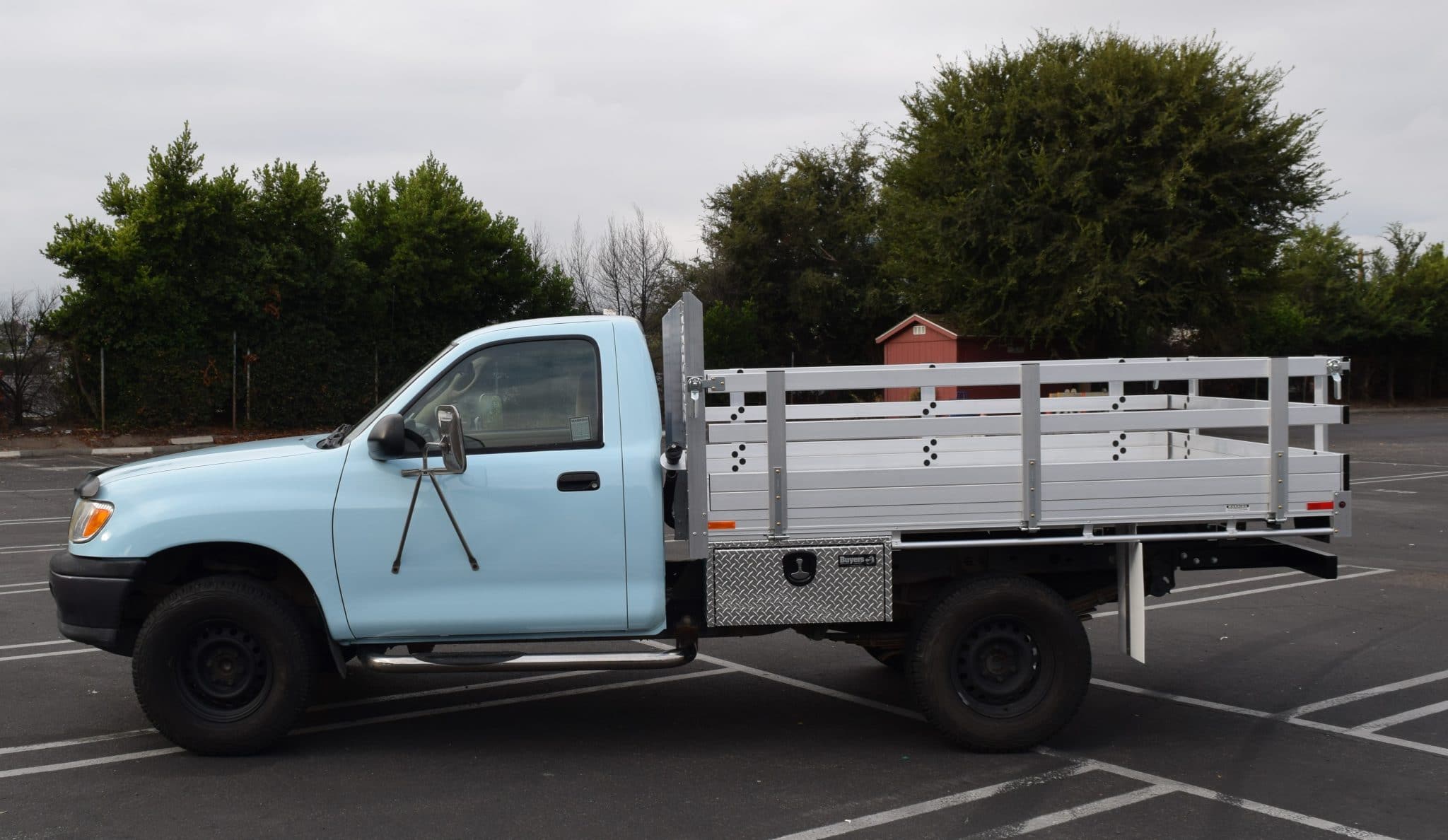 2005 Toyota Tacoma with a 6'X 5'6" AlumBody aluminum stake bed with 30" lift-out stakes using the factory bumper