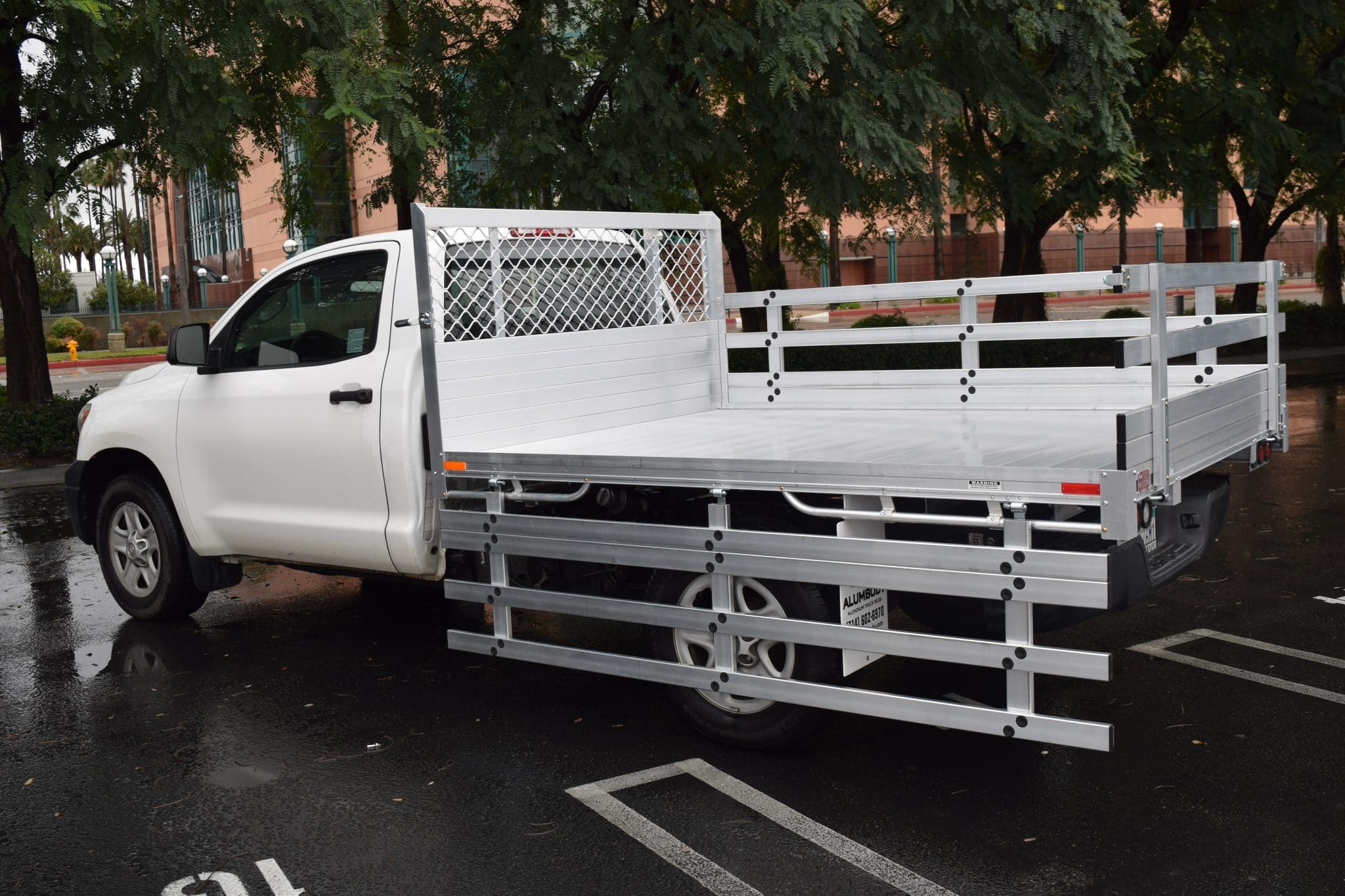 2017 Toyota Tacoma with a 6'X6'6" AlumBody stake bed, 33" lift-out gate using the factory bumper and customer-supplied cabinets