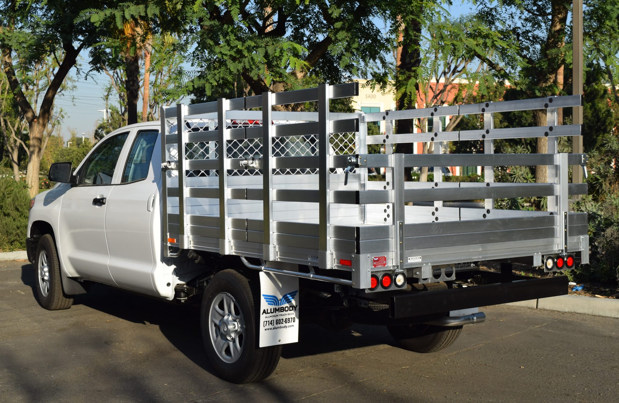 2001 Toyota Tundra with a 6'6" X 9' AlumBody aluminum flat bed, 22" fold-down gates, underbody tool box 14"X12"X30", and dock bumper